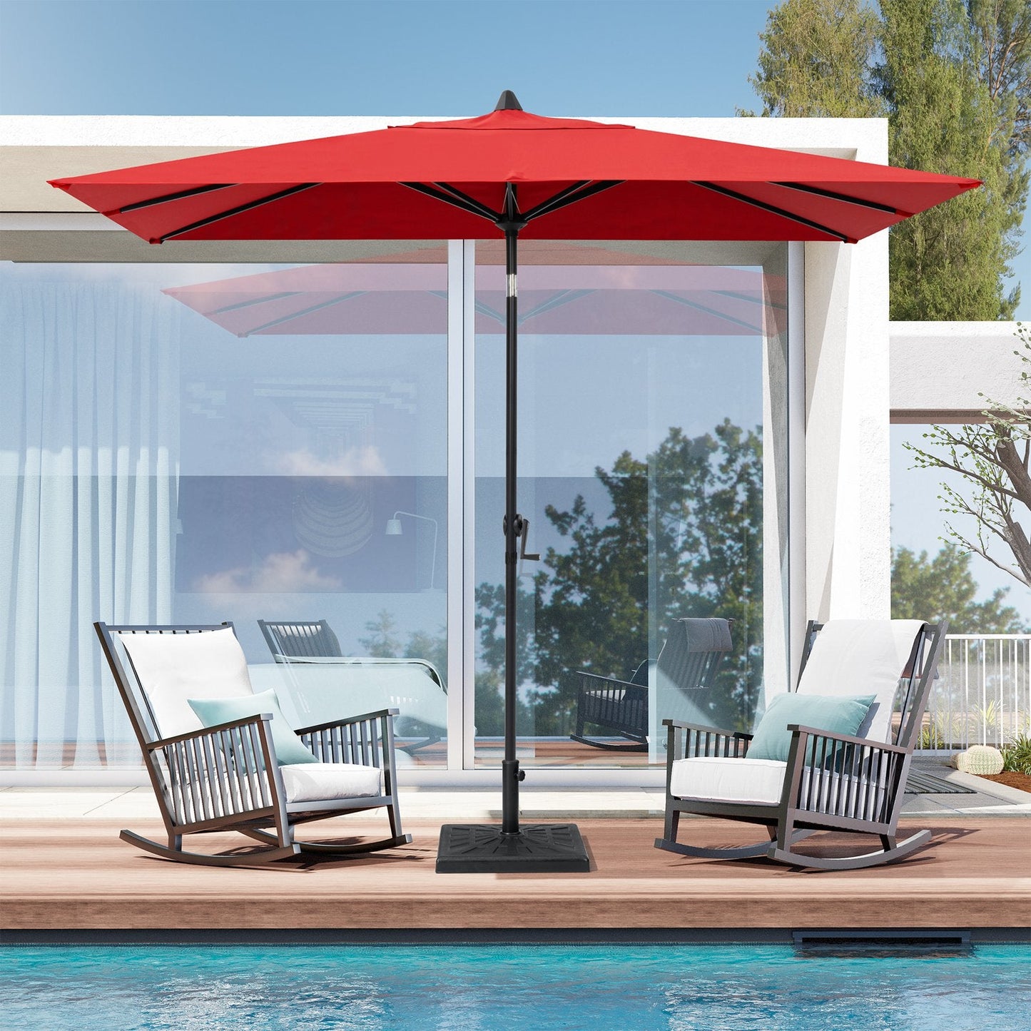 9x5 ft red aluminum rectangular market umbrella shading two patio rocking chairs by a poolside deck.