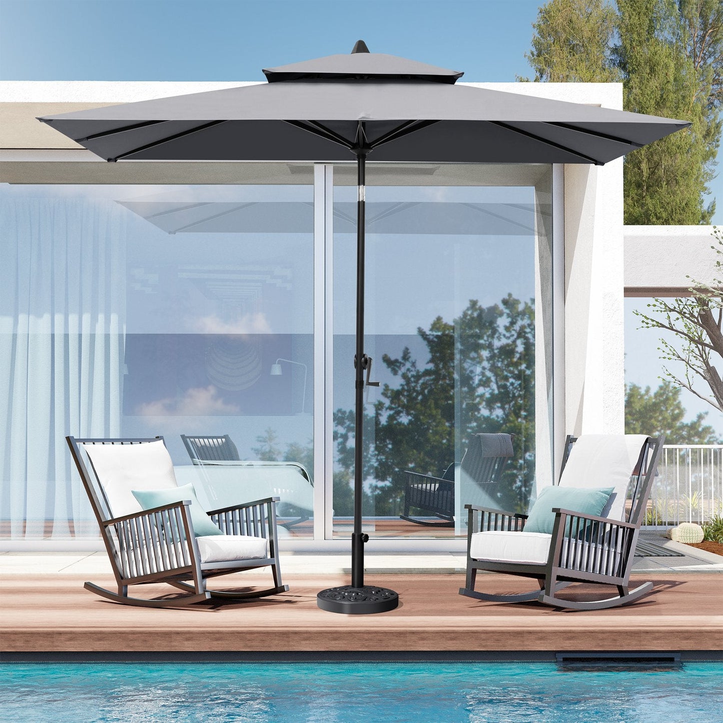 9x5 ft grey aluminum market umbrella with double top shading two patio rocking chairs by a poolside deck.