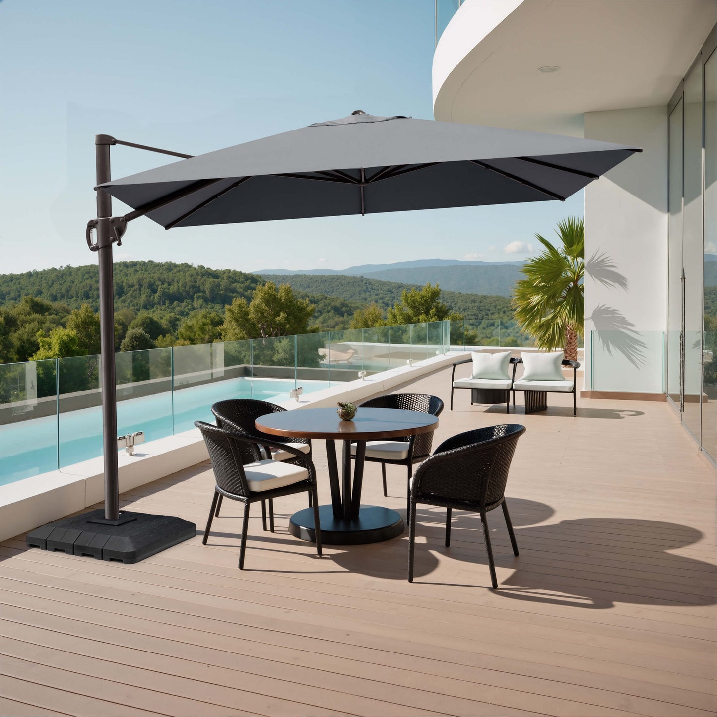 Grey rectangular cantilever umbrella with weighted base shading a poolside patio dining set.