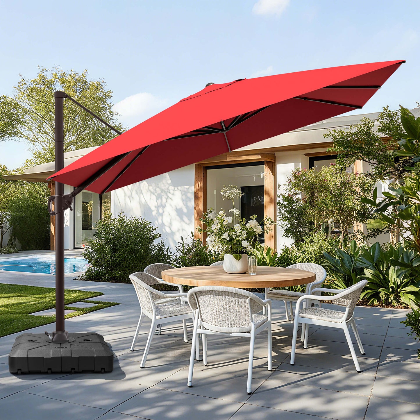Red rectangular cantilever umbrella with wheeled base over patio dining set.