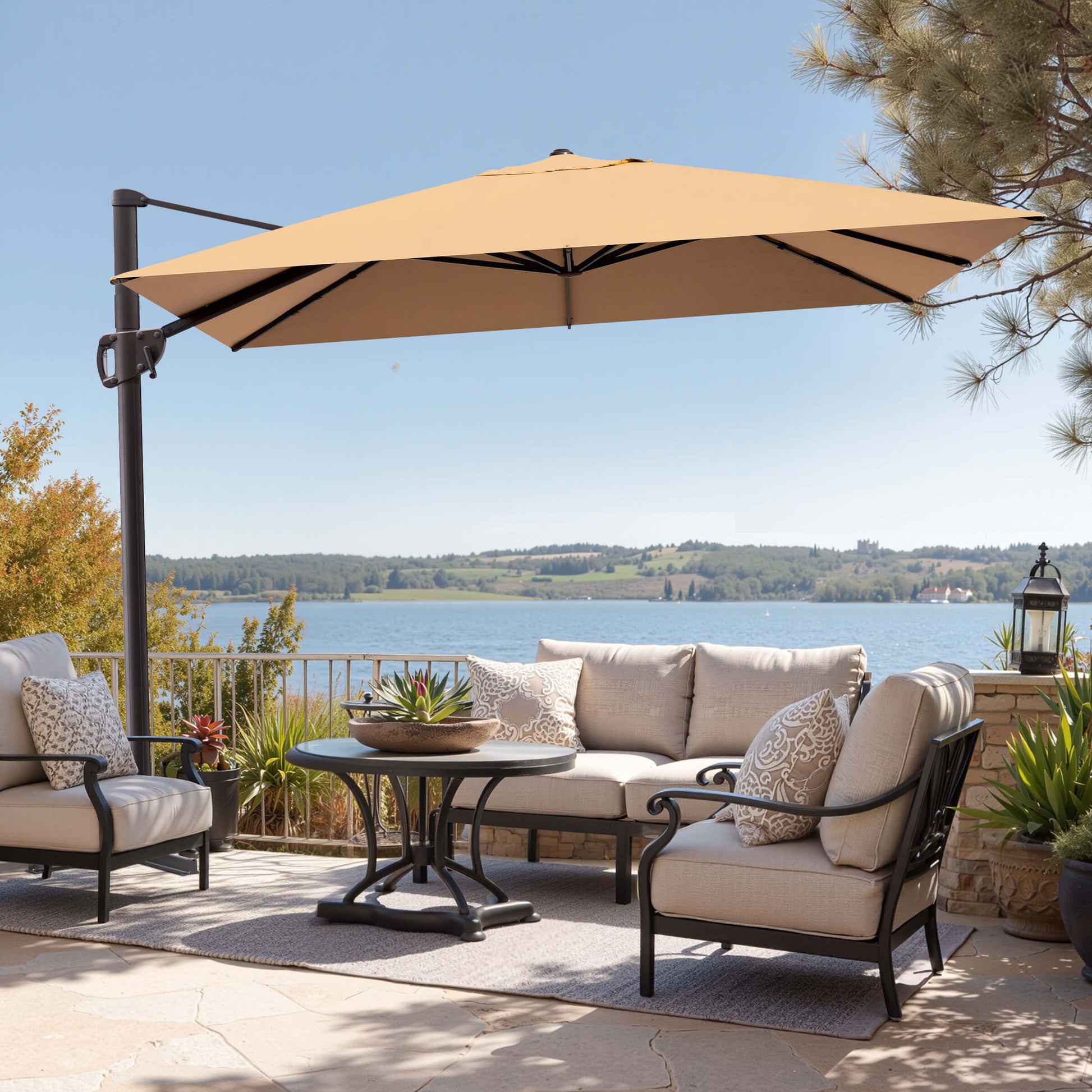 Beige rectangular cantilever umbrella over outdoor patio lounge seating area with lake view.