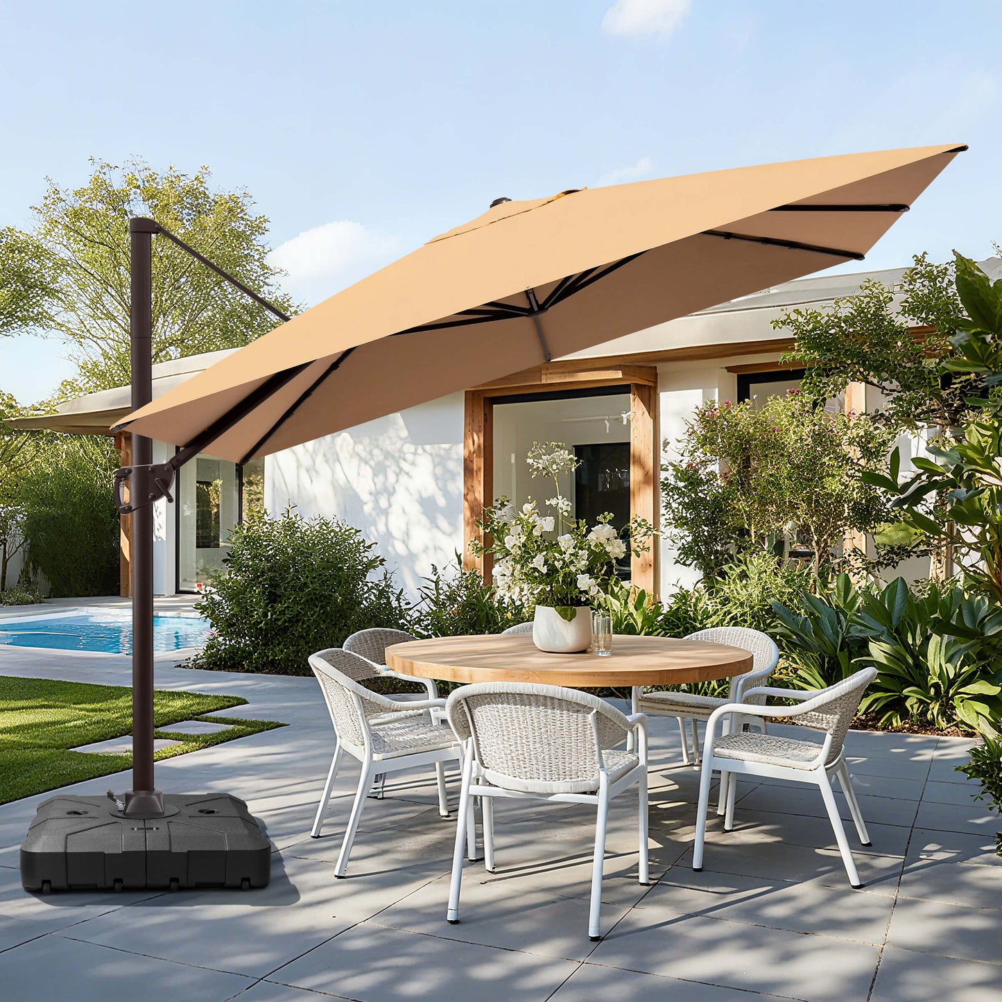 Beige rectangular cantilever umbrella with weighted base over patio dining set.