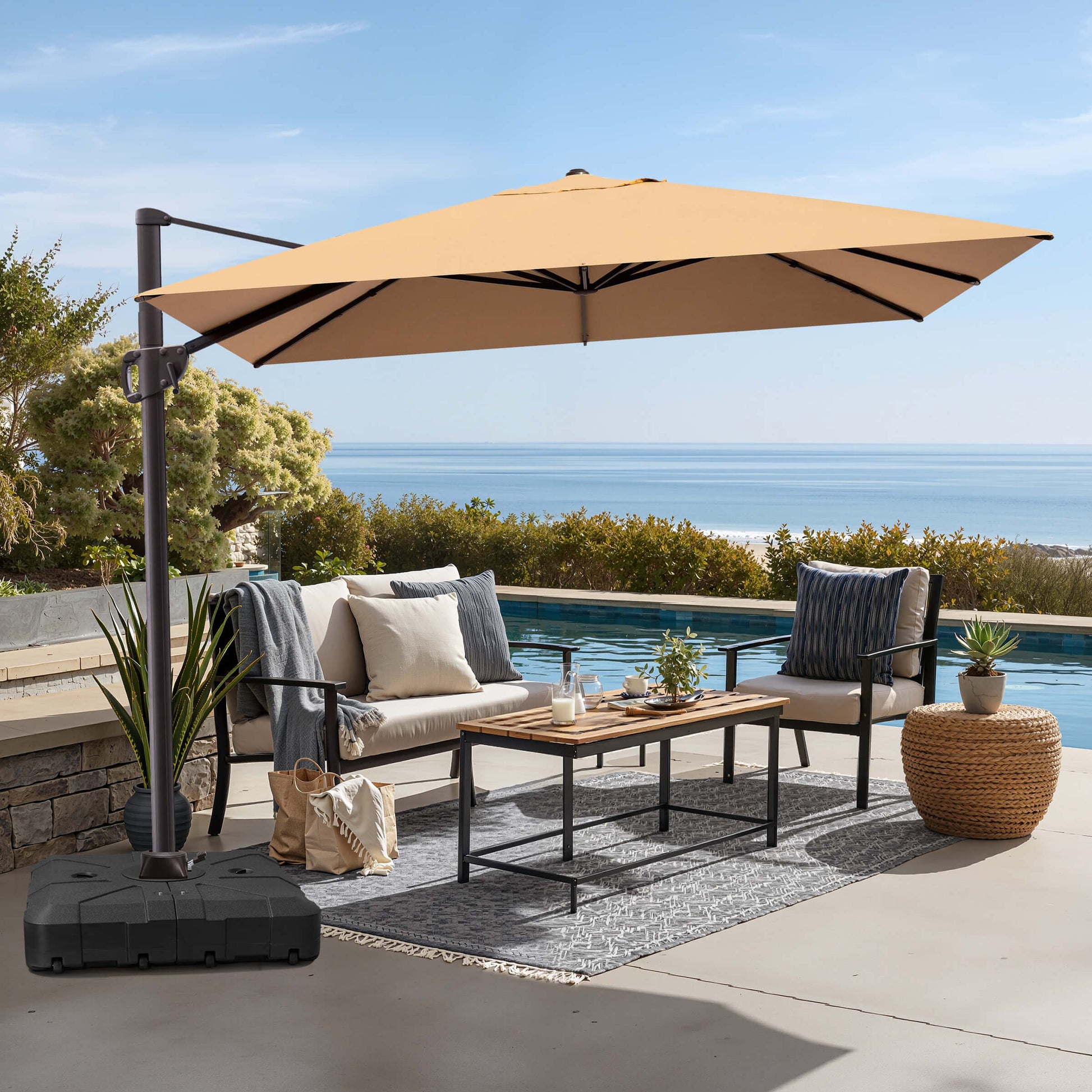 Beige rectangular cantilever umbrella with weighted base over poolside patio seating.
