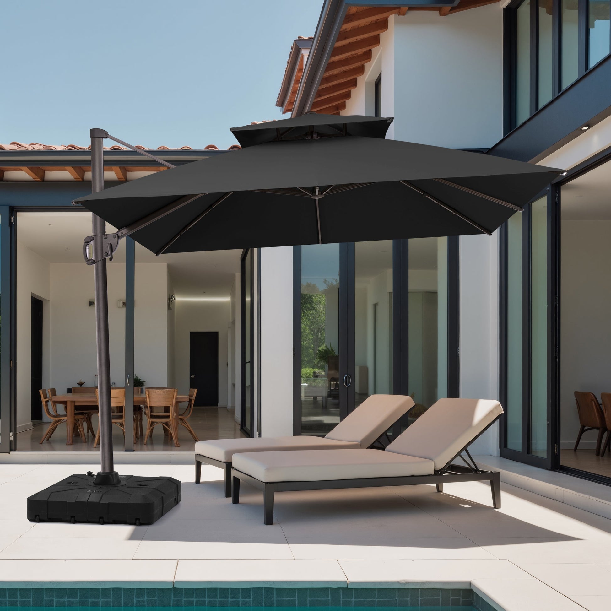 Crestlive 12x9 ft black patio cantilever umbrella with heavy-duty base shading poolside lounge chairs at a modern villa