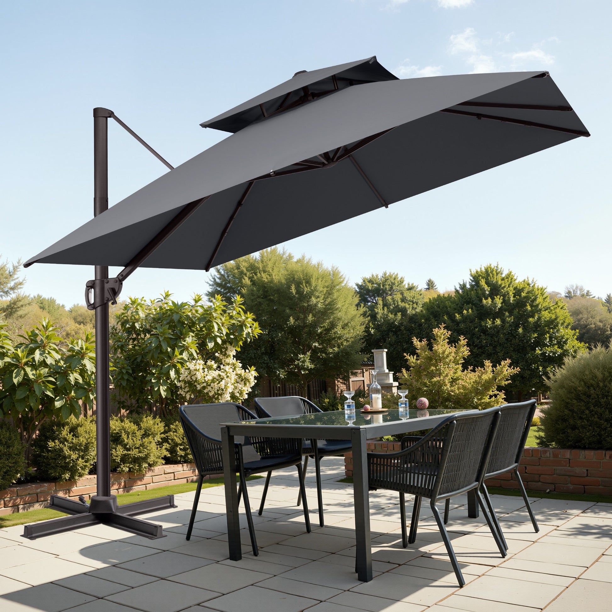 Tilted 10x10 ft square grey cantilever patio umbrella with steel cross base shading a patio dining set