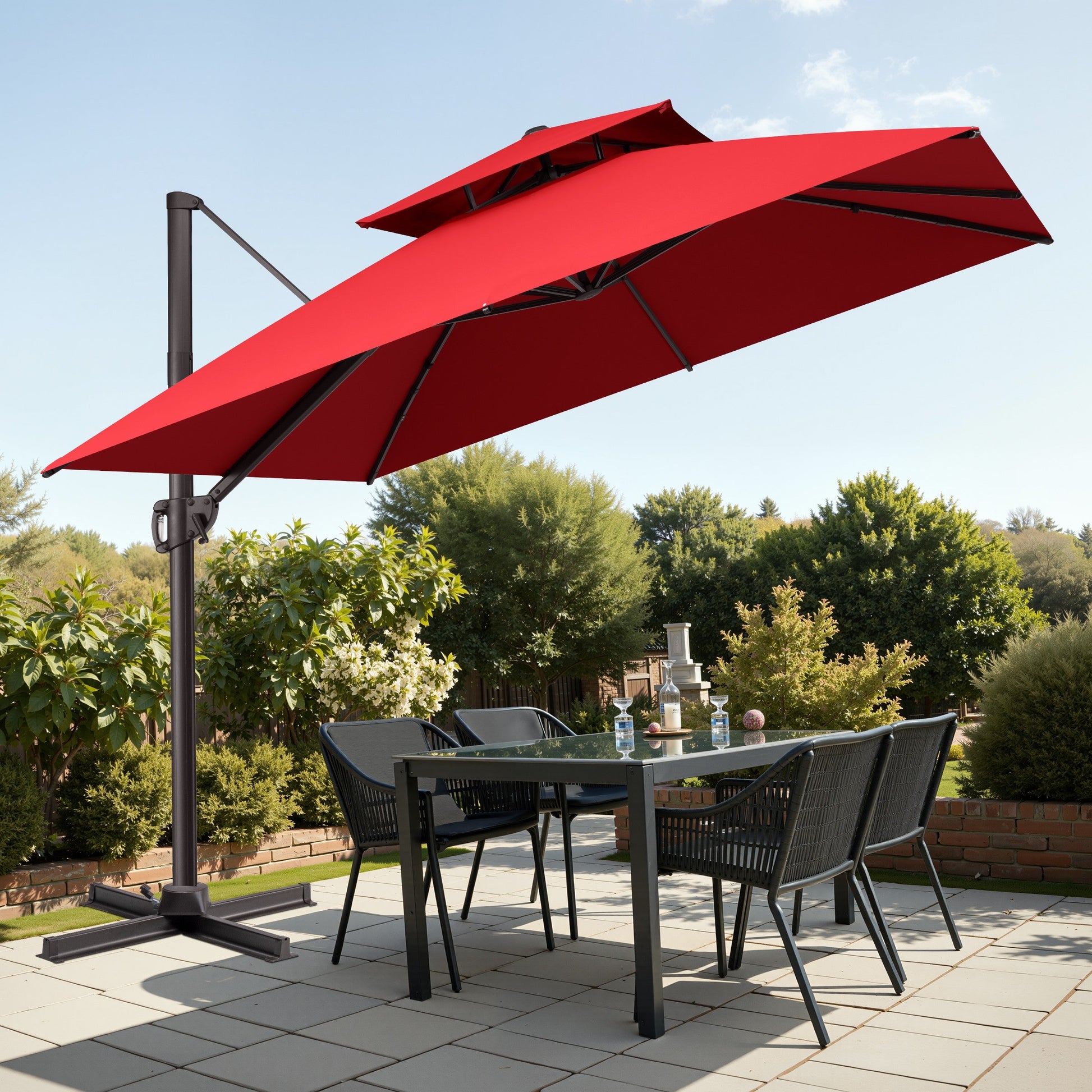 Tilted 10x10 ft square red cantilever patio umbrella with steel cross base shading a patio dining set