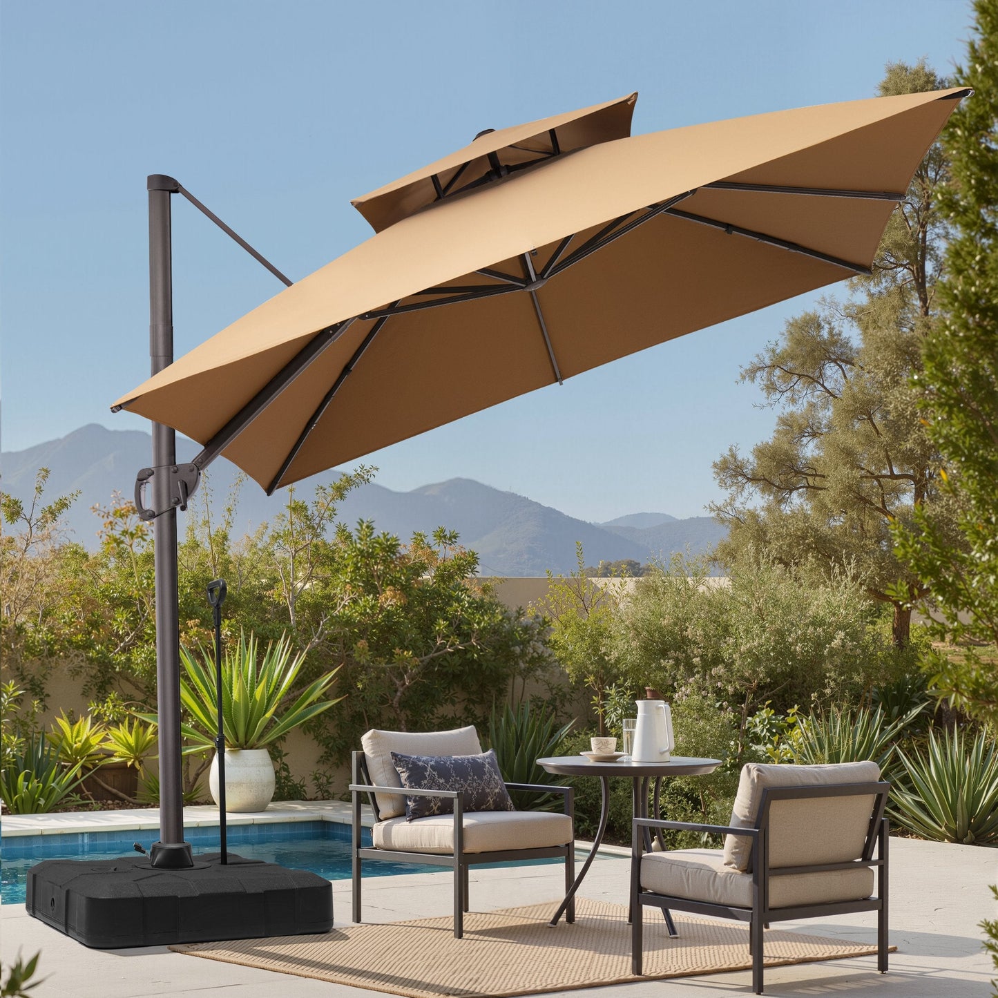 Tilted 10x10 ft square beige cantilever patio umbrella with wheeled base shading a poolside dining set