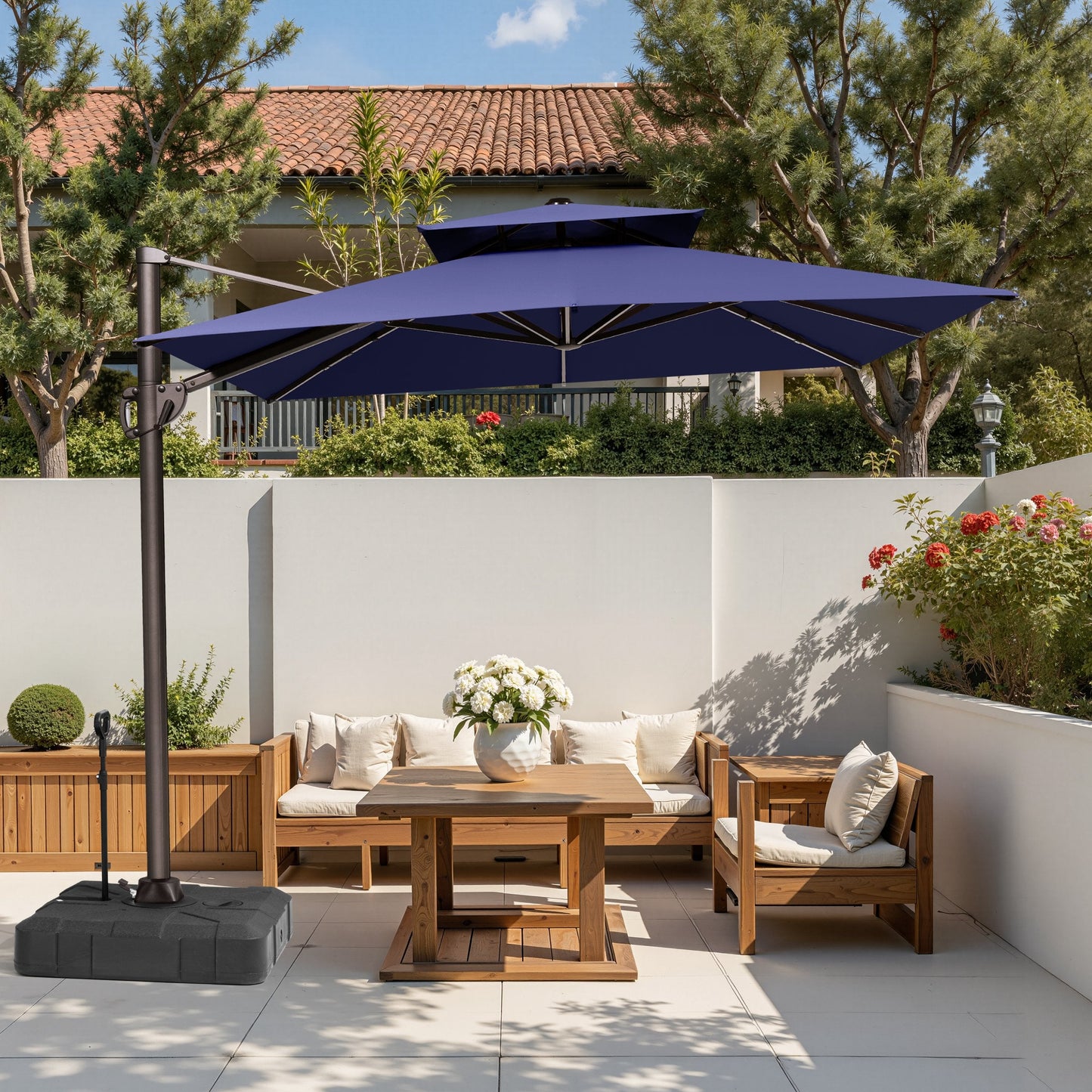 Crestlive 11x9 ft navy blue cantilever umbrella with wheeled base shading a wooden patio furniture set in a courtyard