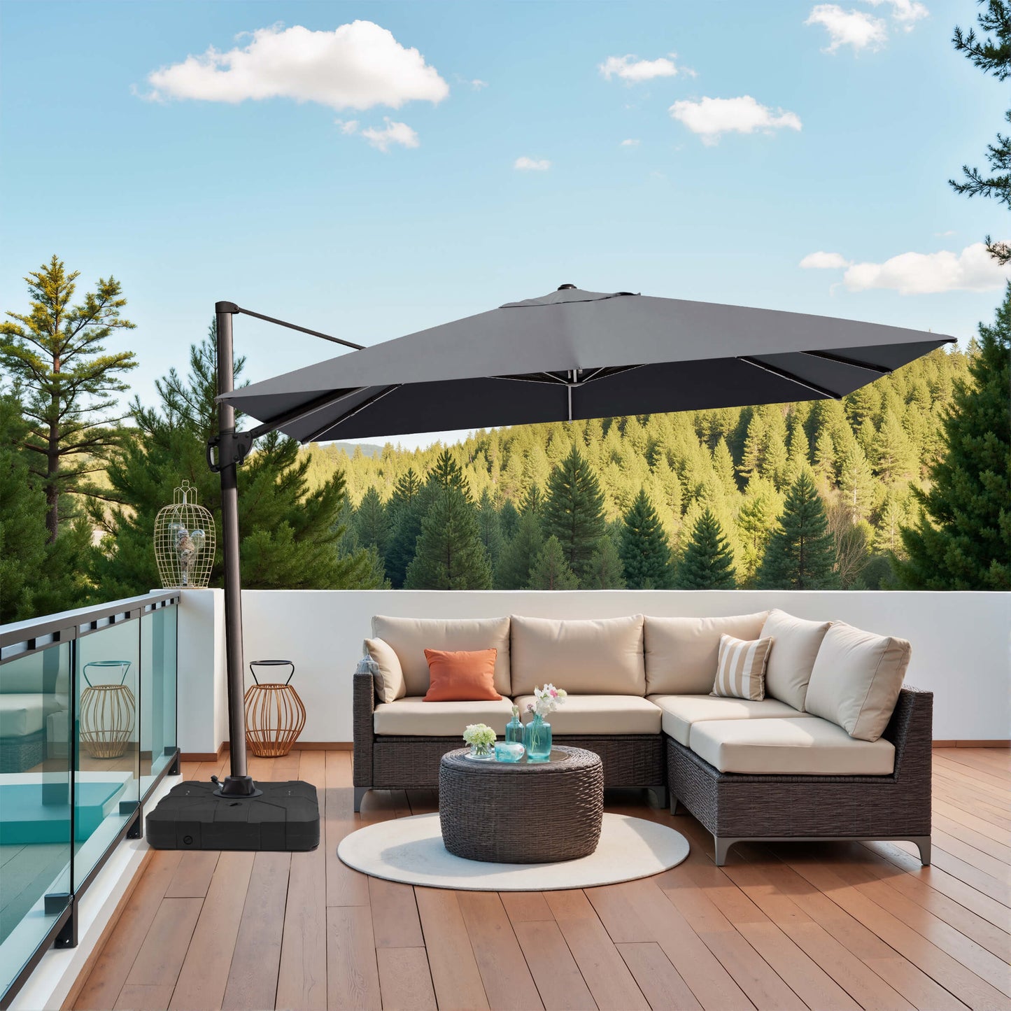 Grey rectangular cantilever umbrella with Weighted base over patio sofa.