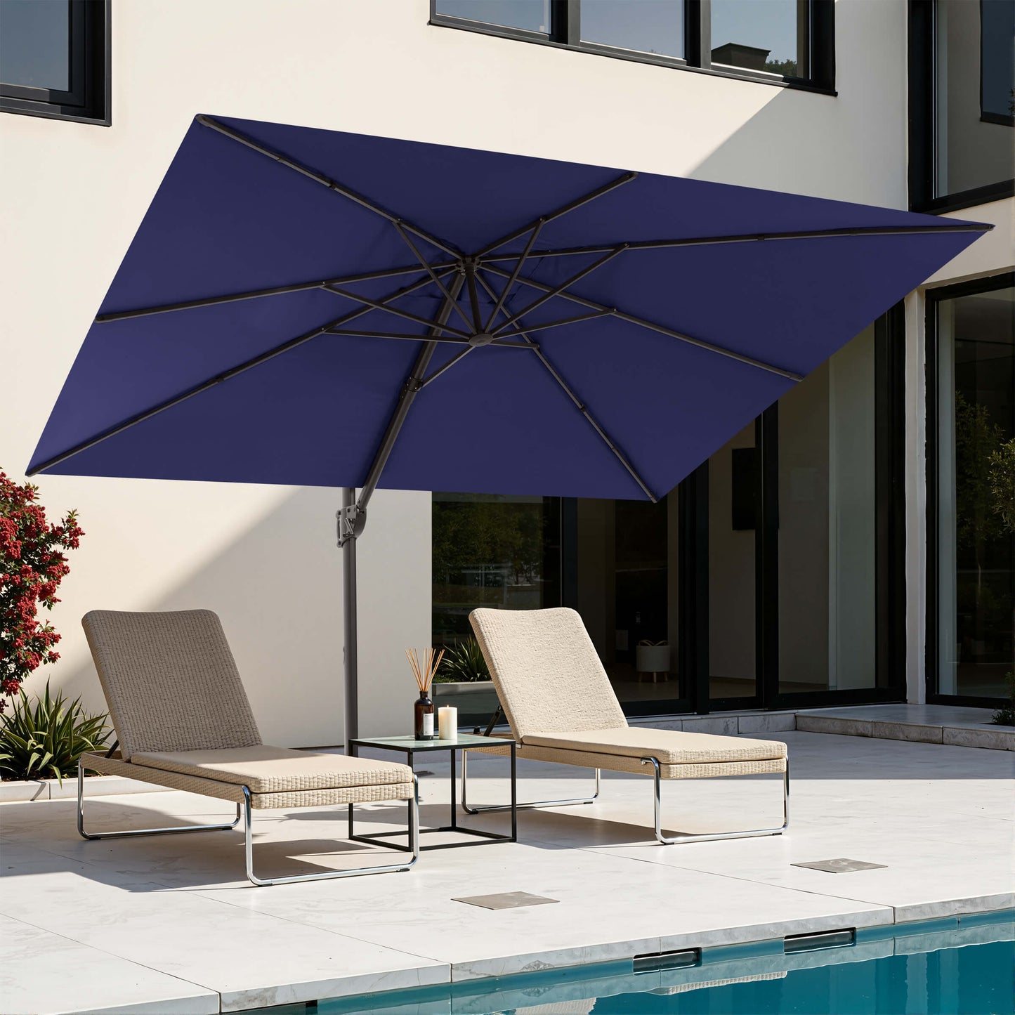 Navy blue rectangular cantilever patio umbrella over poolside lounge chairs.