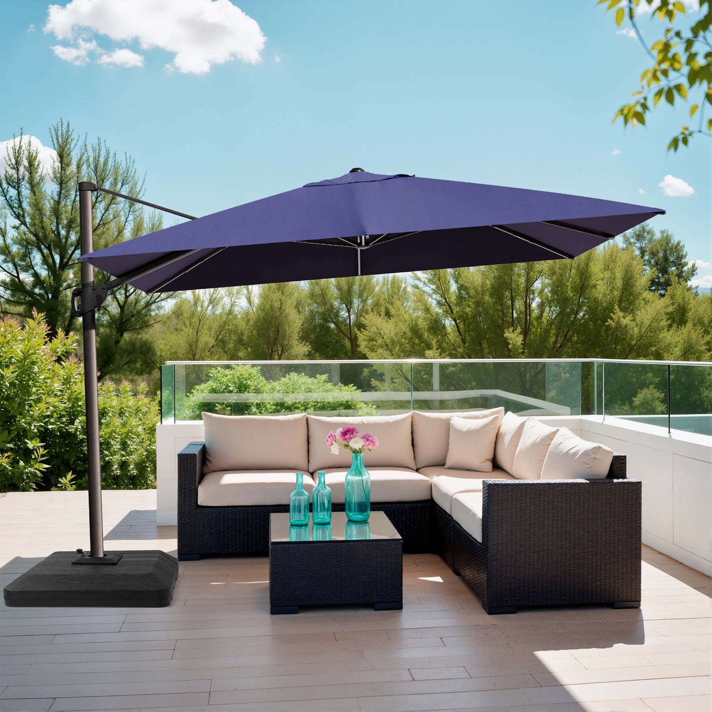 Navy blue rectangular cantilever umbrella with weighted base over patio sofa.