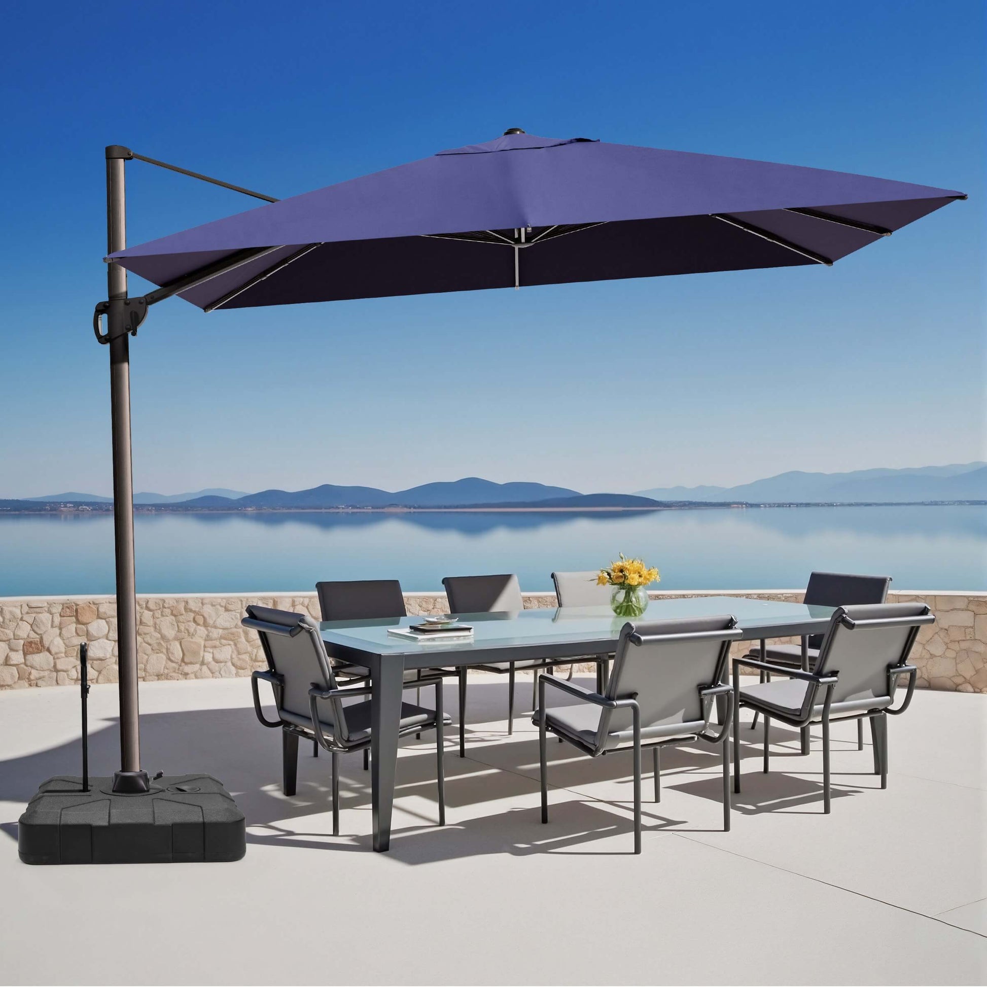 Navy blue rectangular cantilever umbrella with pull-rod base over outdoor dining set.