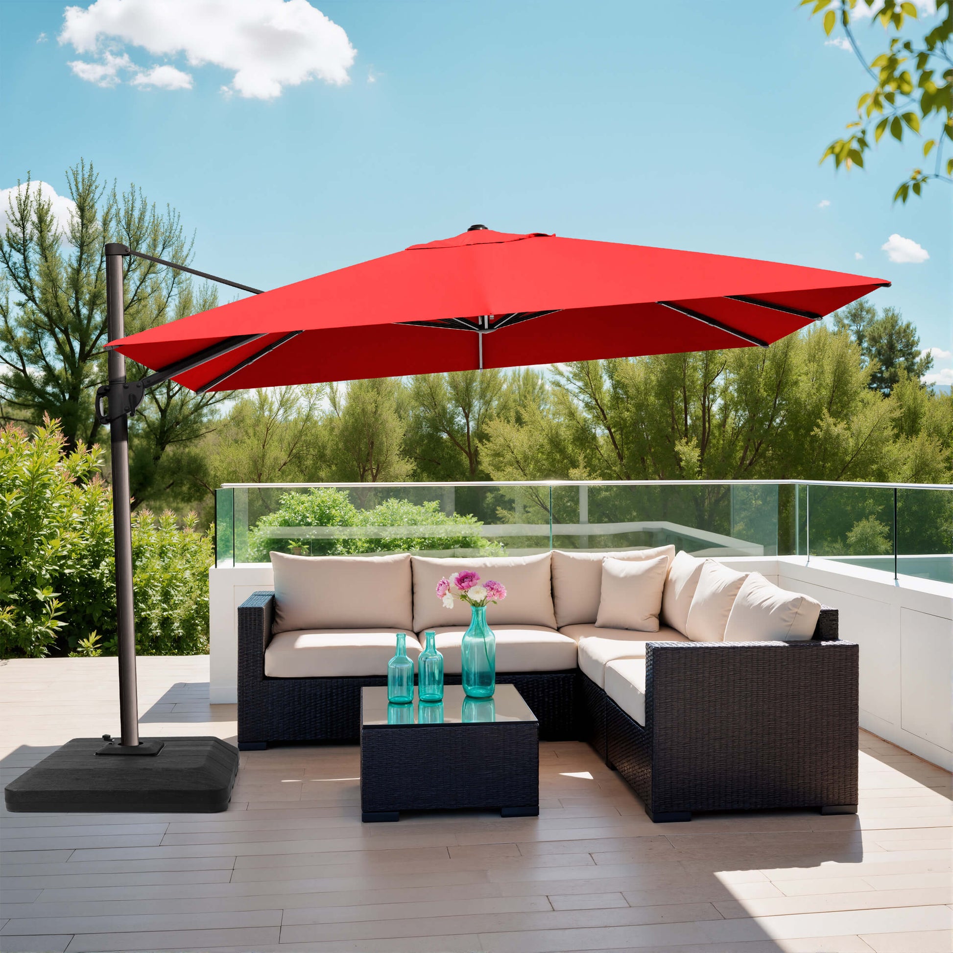 Red rectangular cantilever umbrella with weighted base over patio sofa.