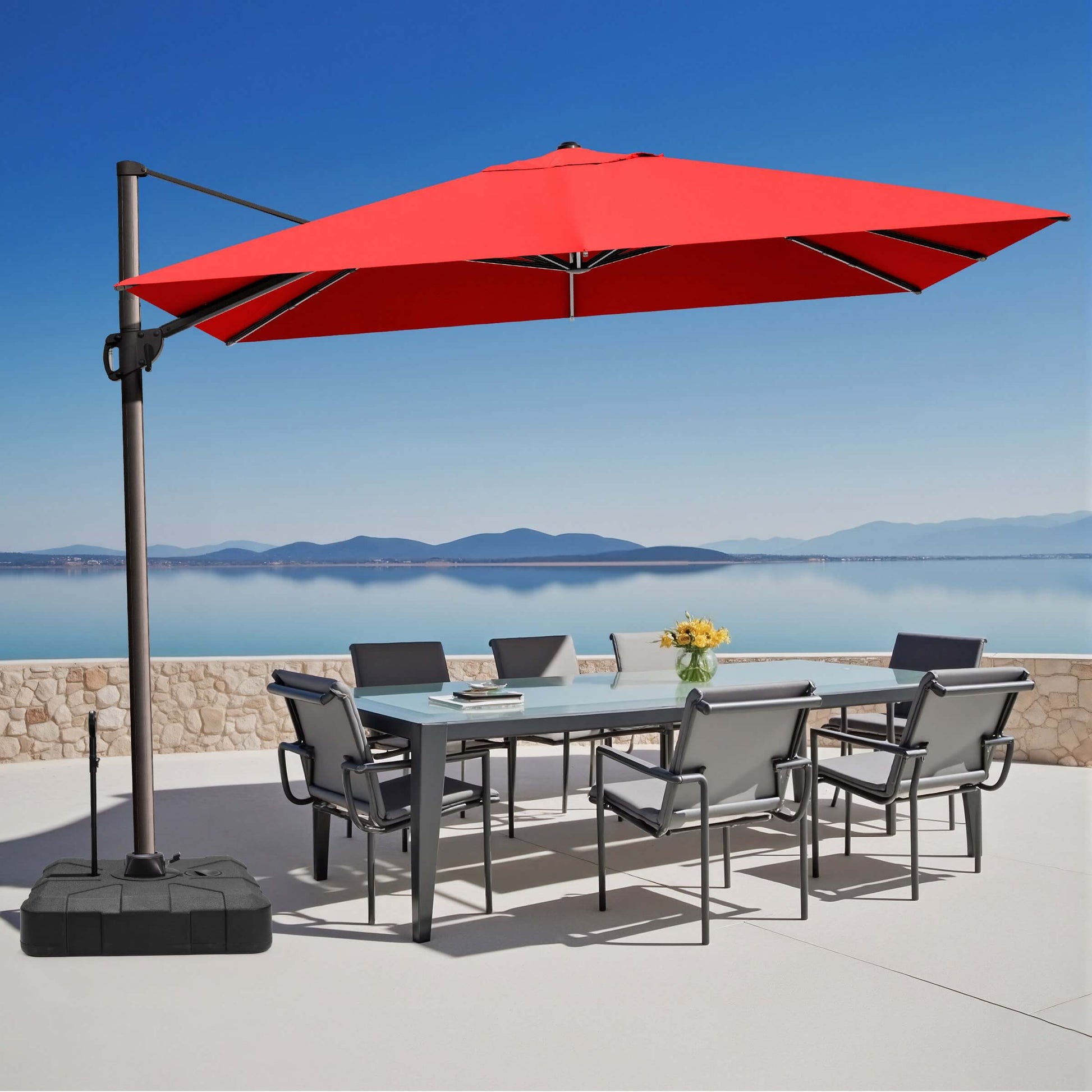 Red rectangular cantilever umbrella with pull-rod base over outdoor dining set.