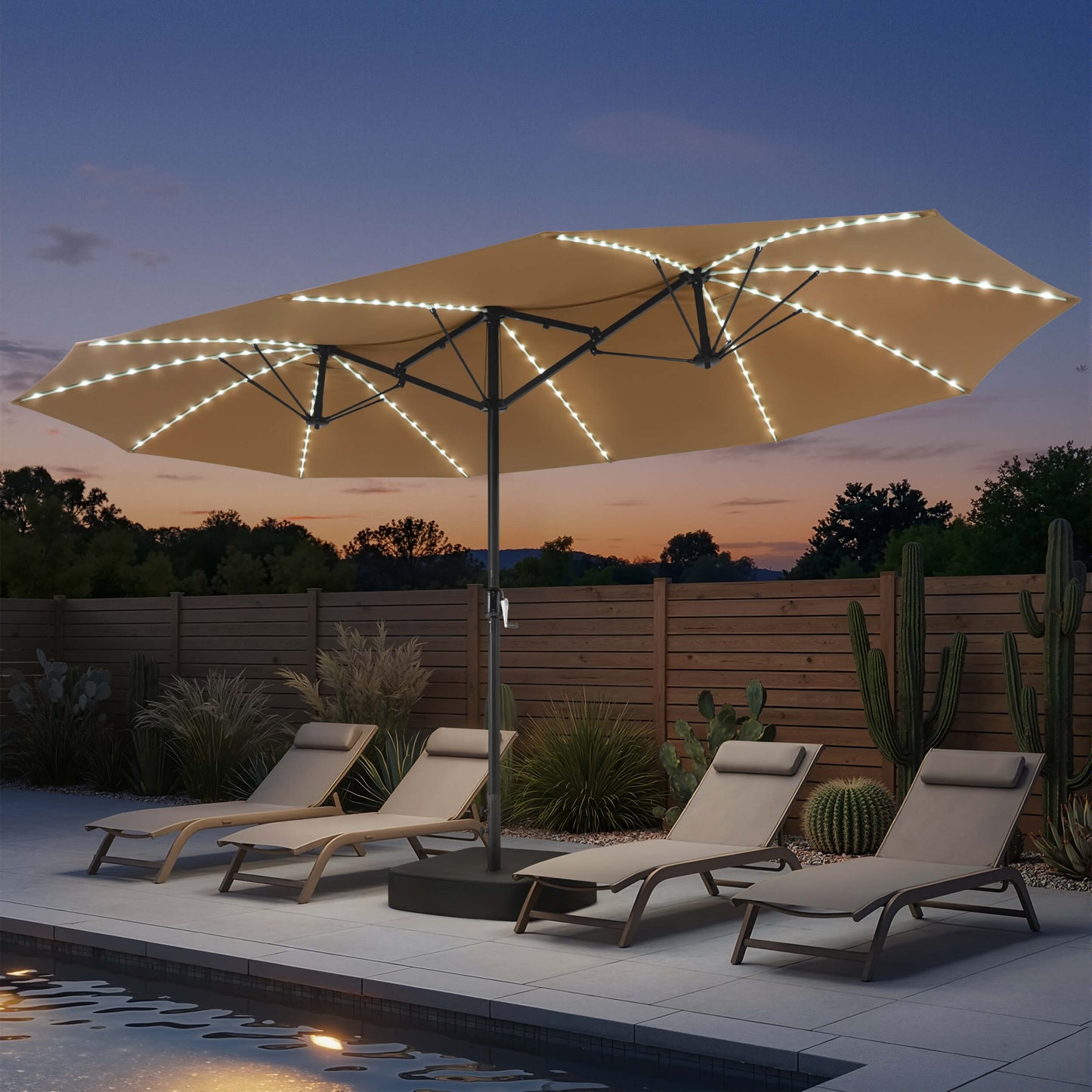 15x9 ft beige double-sided market umbrella with solar LED lights shading poolside chaise lounges at night.