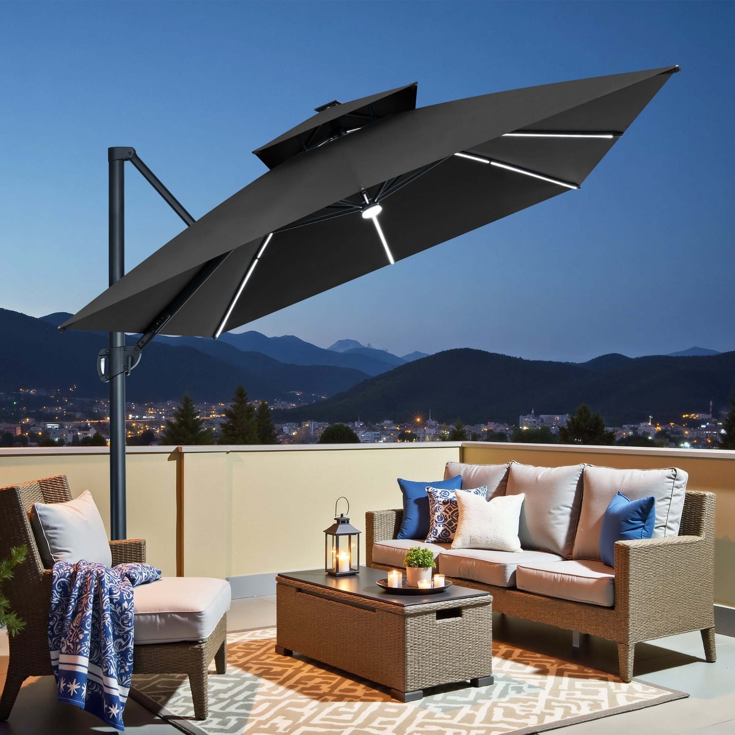 Black LED cantilever patio umbrella illuminating an evening balcony seating area.