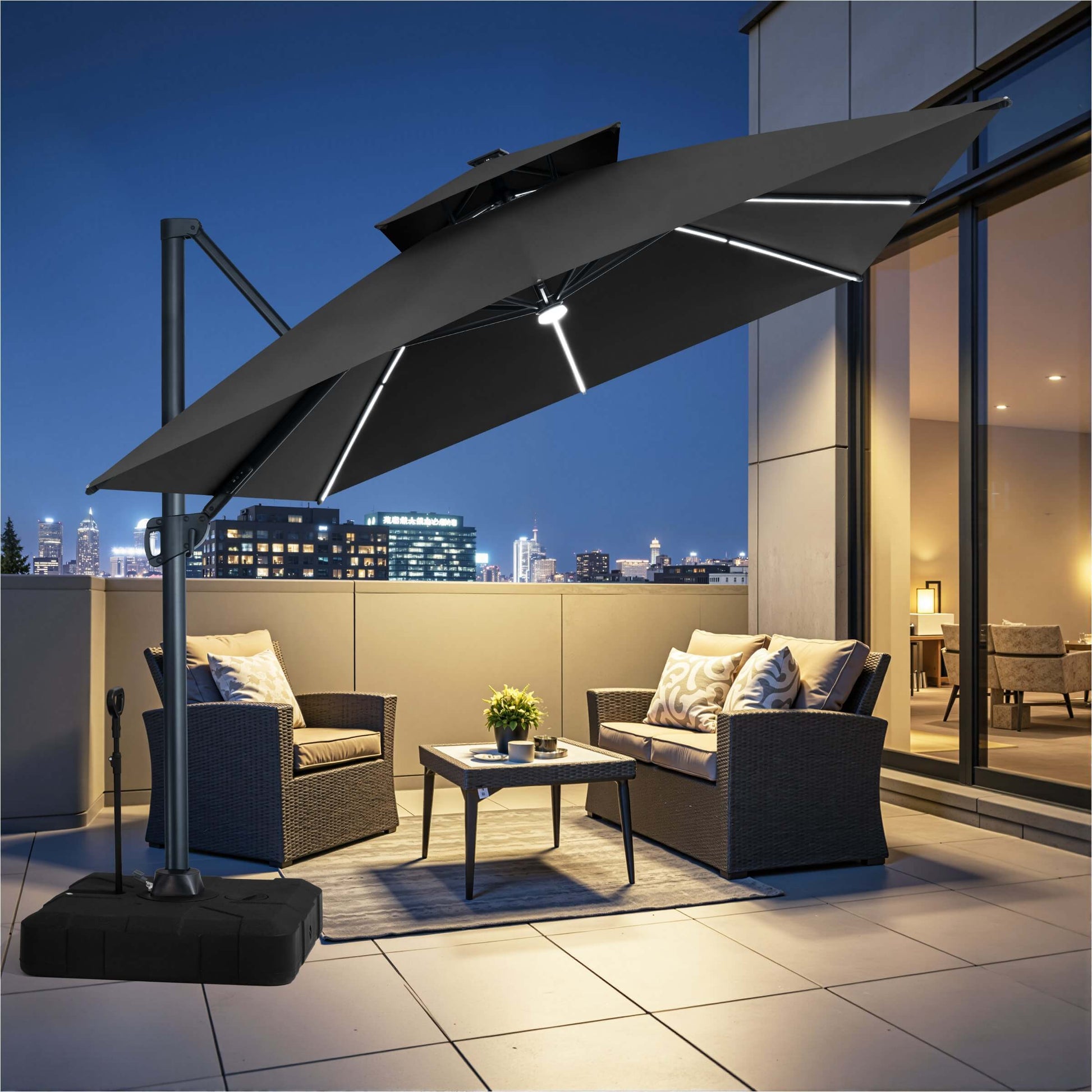 Black LED cantilever patio umbrella with pull-rod wheeled base illuminating an evening balcony seating area.