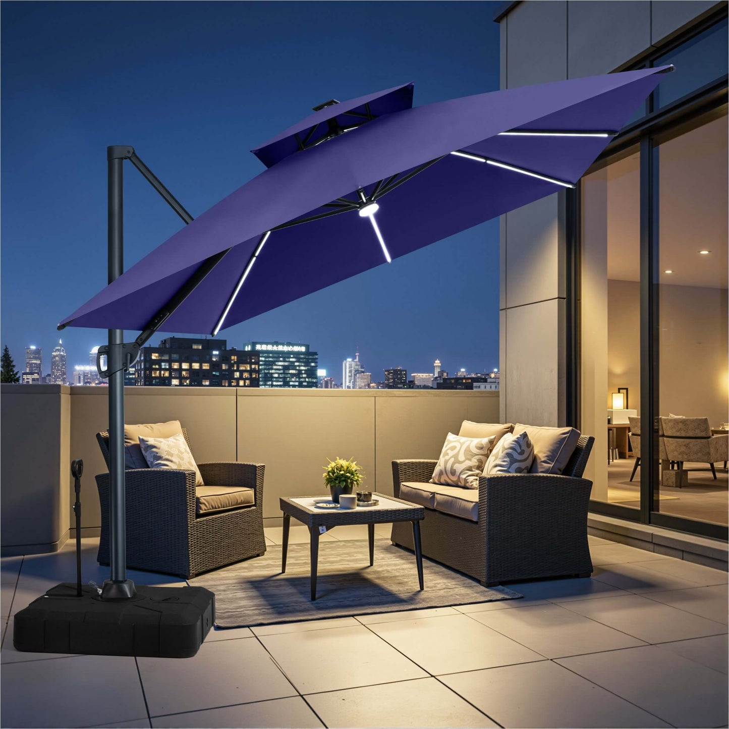 Navy blue double-top cantilever patio umbrella with integrated LED light strips and wheeled base illuminating rooftop terrace.