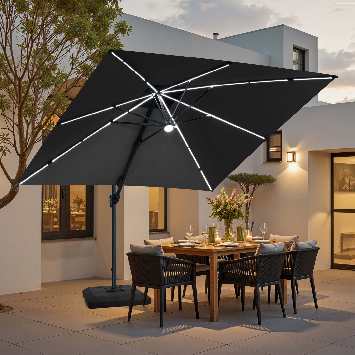 Black LED cantilever umbrella on a weighted base over a patio dining set.