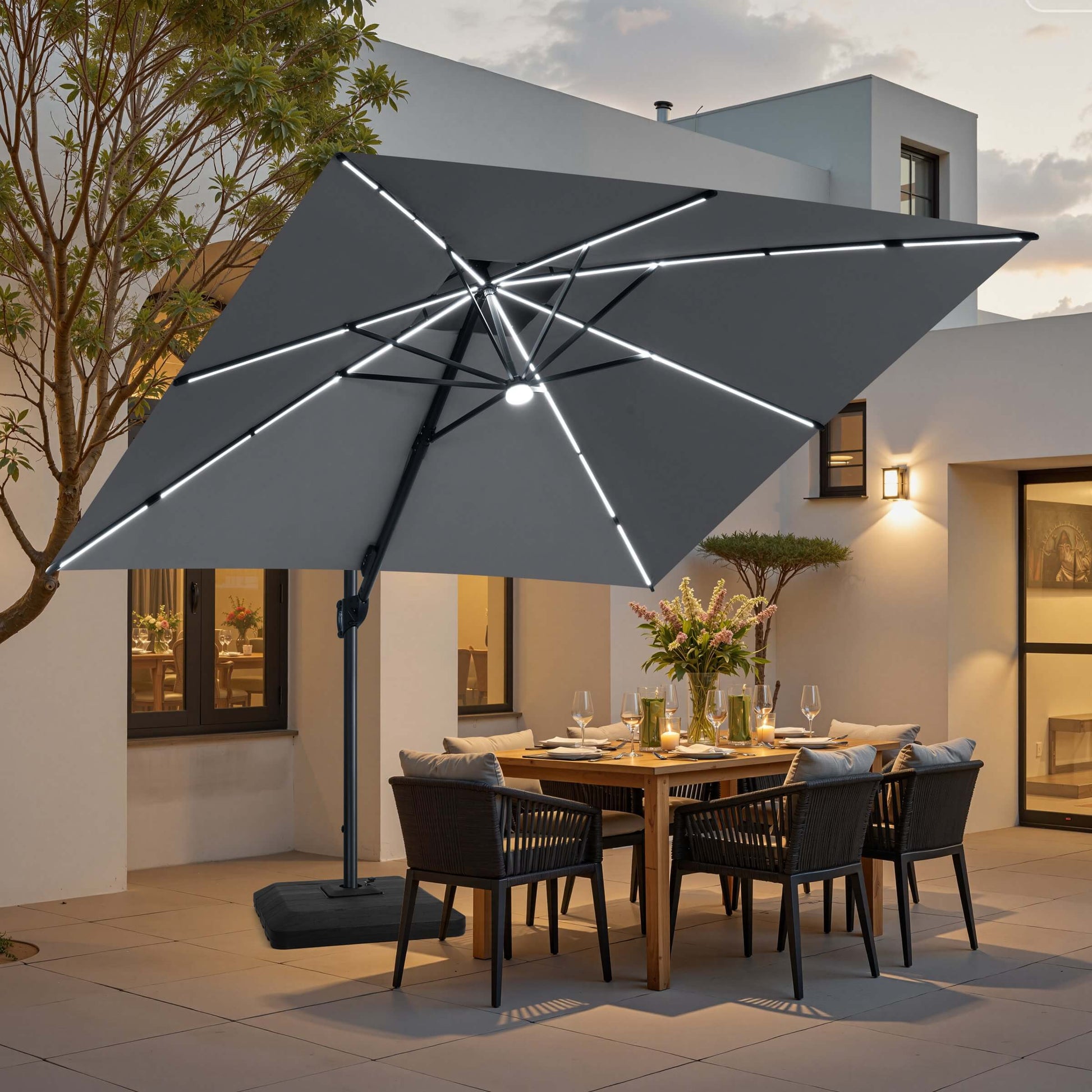 Grey LED cantilever umbrella on a weighted base over a patio dining set.