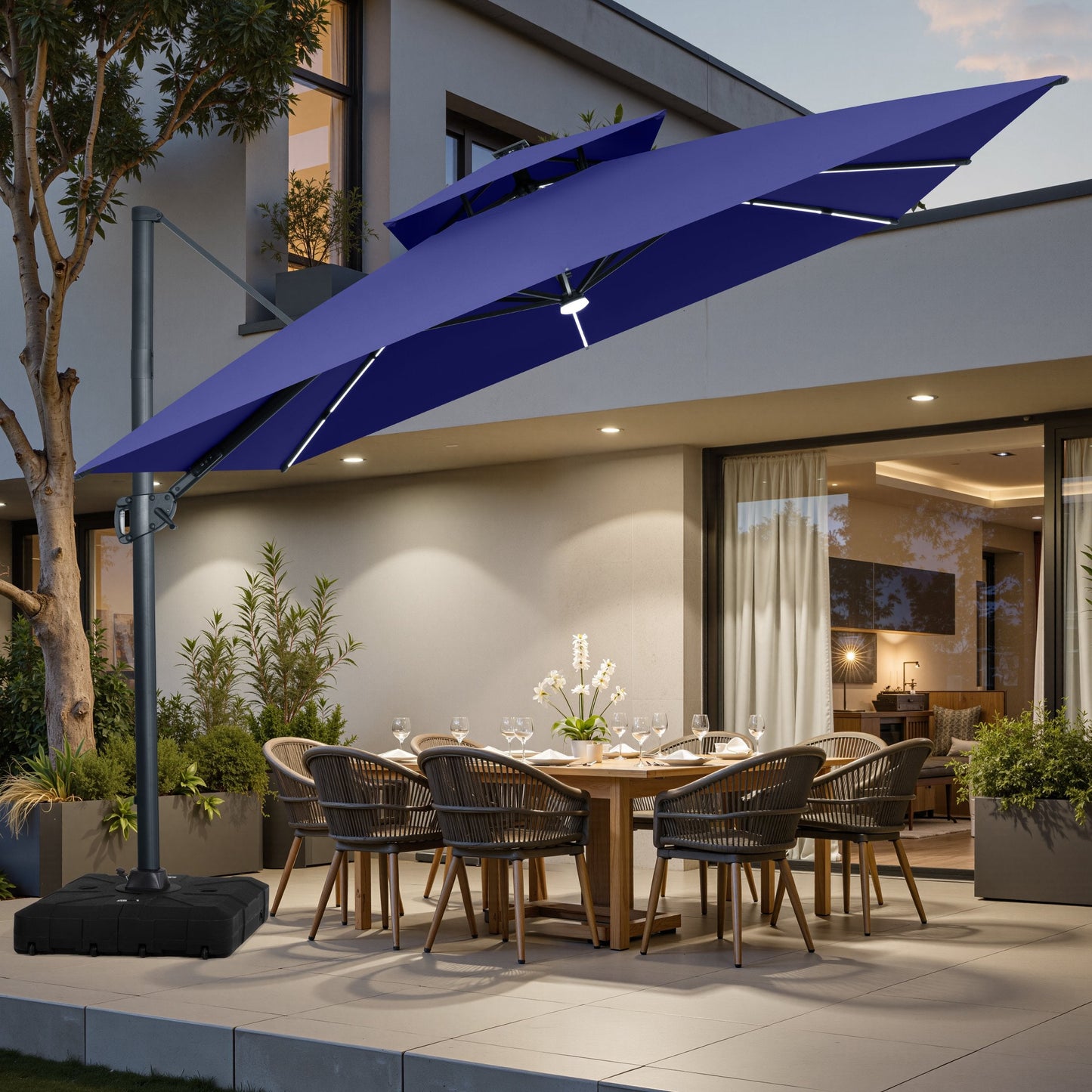 Navy blue LED cantilever umbrella on wheeled base over patio dining set.
