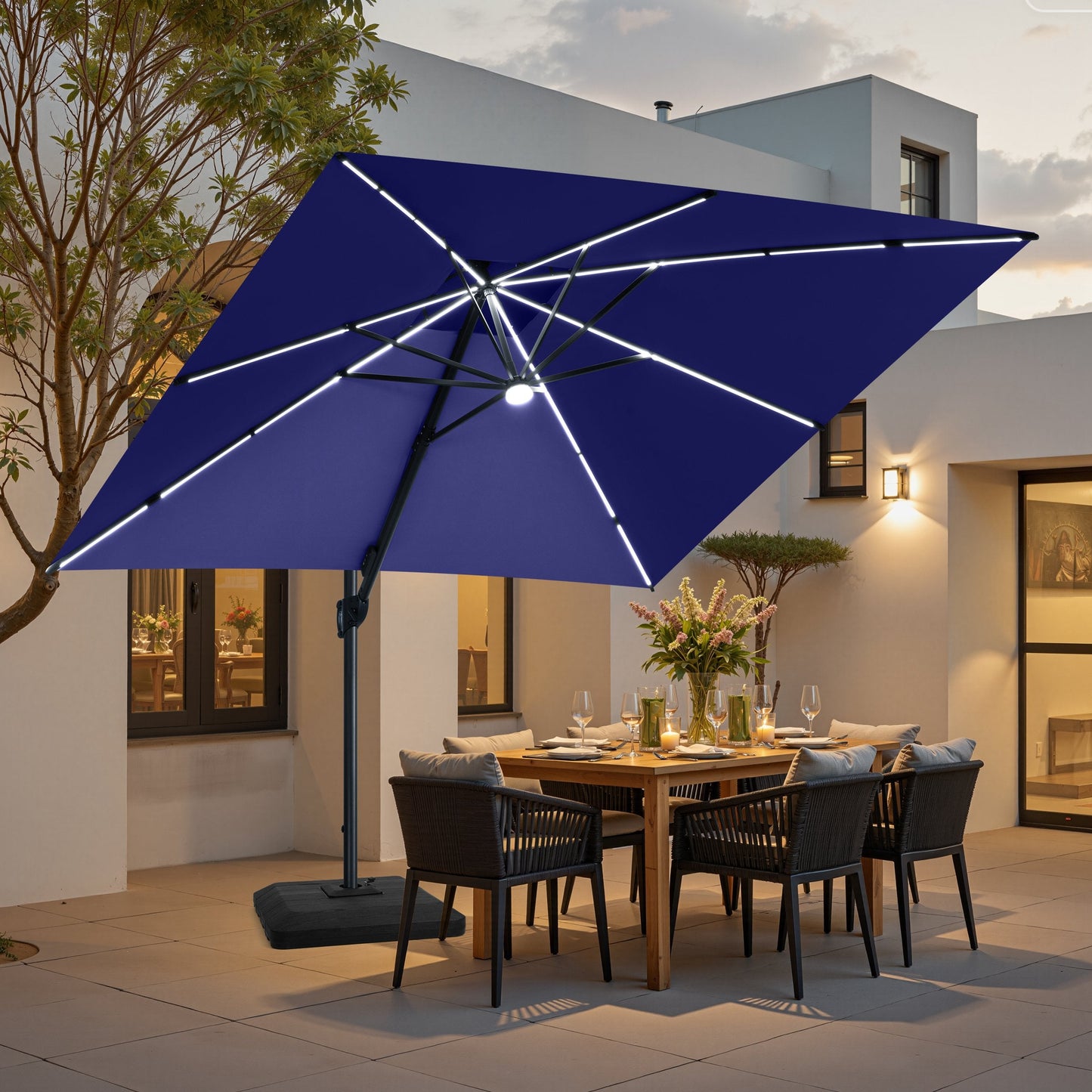 Navy blue LED cantilever umbrella on weighted base over patio dining set.
