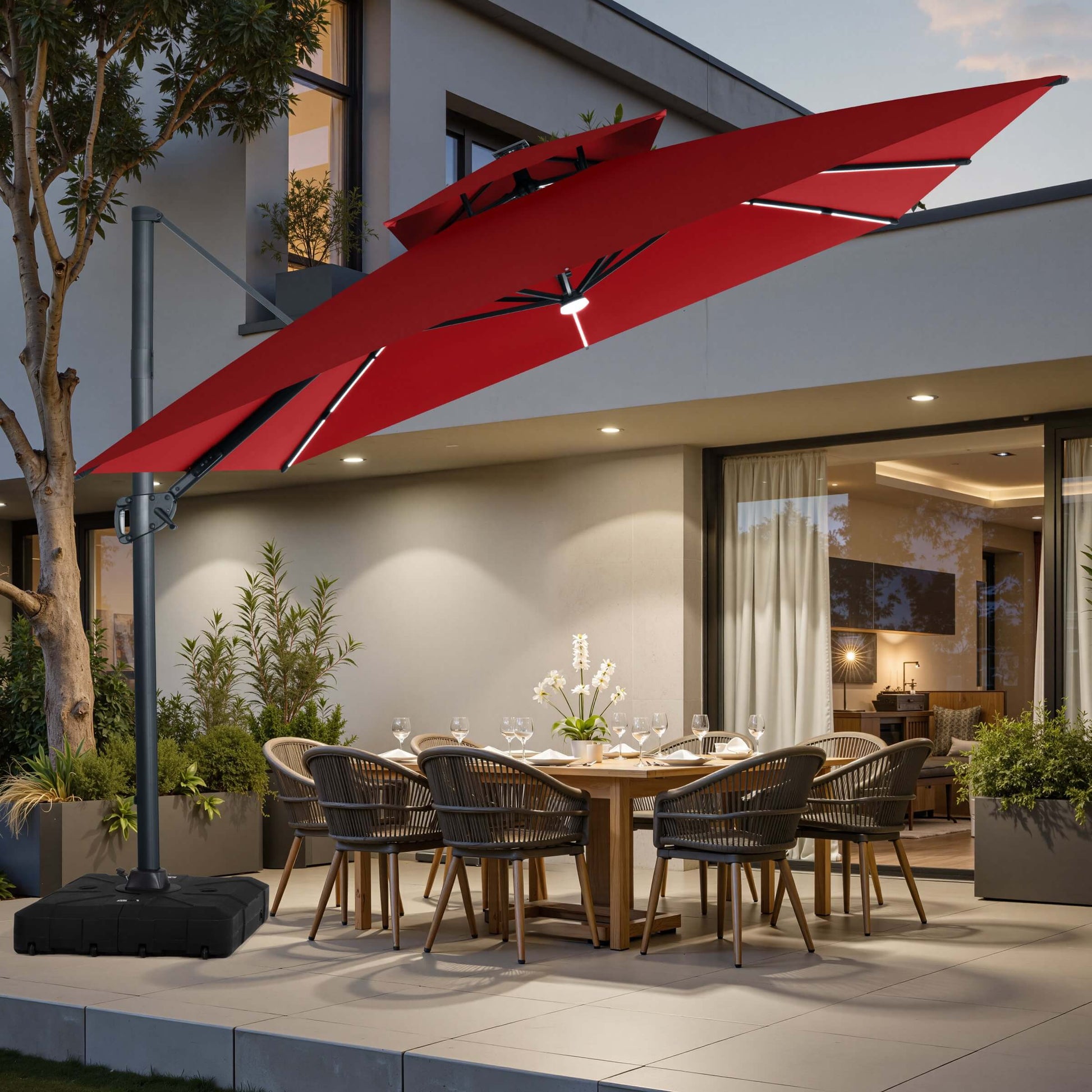 Red LED cantilever umbrella on wheeled base over patio dining set.
