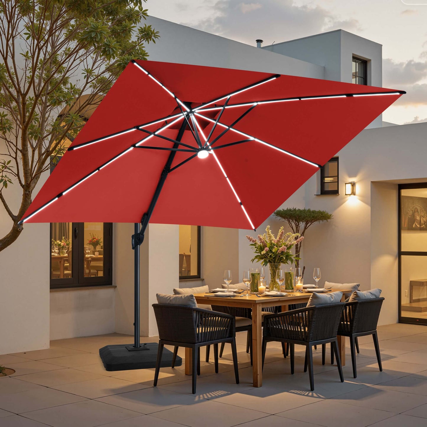 Red LED cantilever umbrella on weighted base over patio dining set.