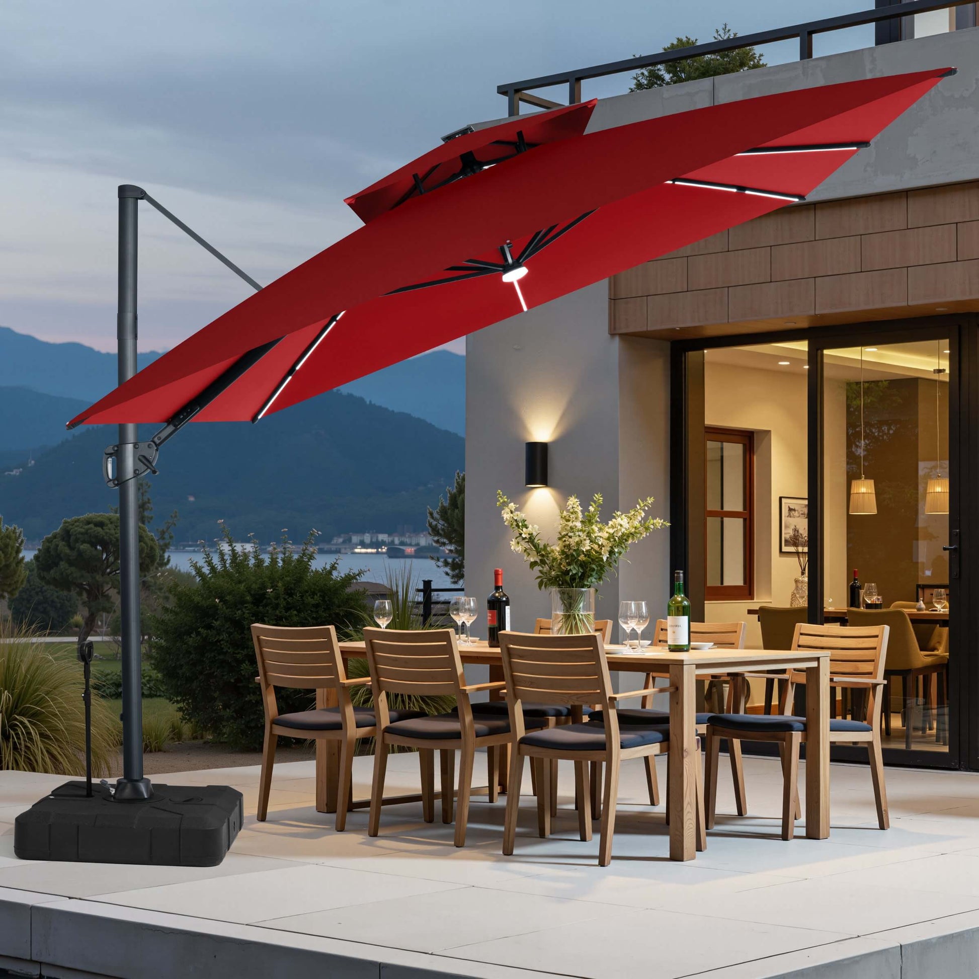 Red LED cantilever umbrella on pull-rod base over a patio dining set.