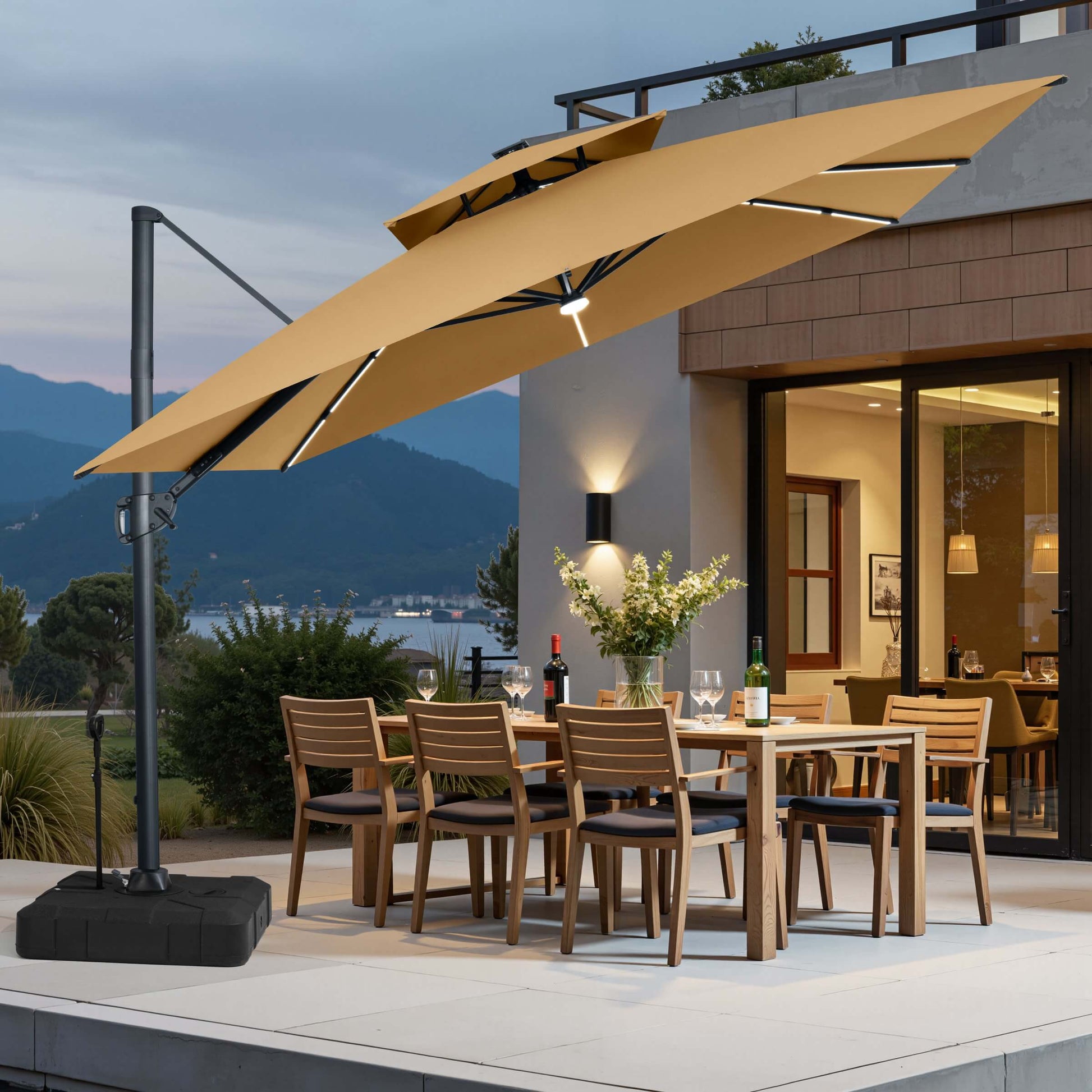 Tilted beige LED cantilever umbrella on pull-rod base over a patio dining set at dusk.