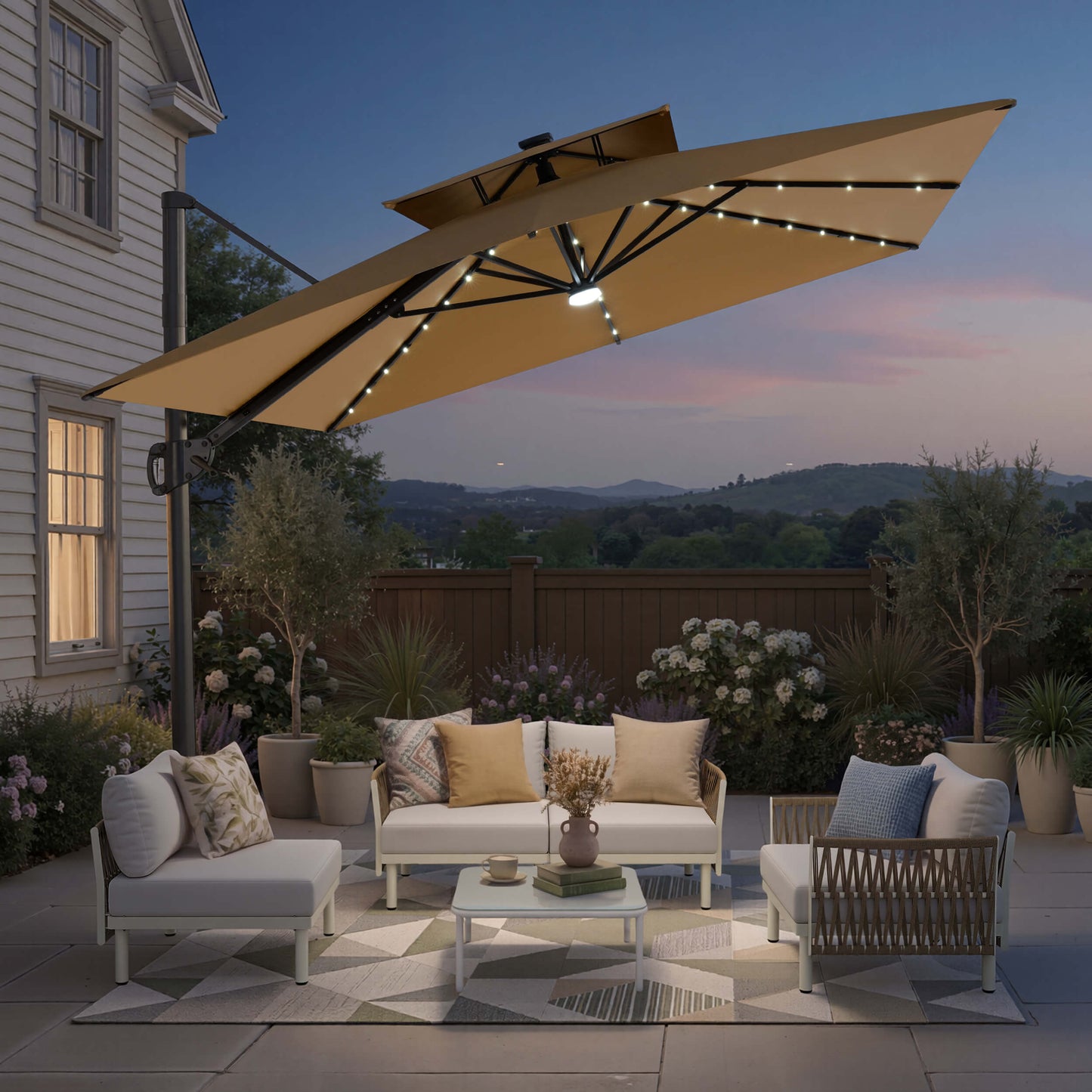 Tilted 12x9 ft beige lighted cantilever umbrella with cross base shading a patio sofa set at twilight