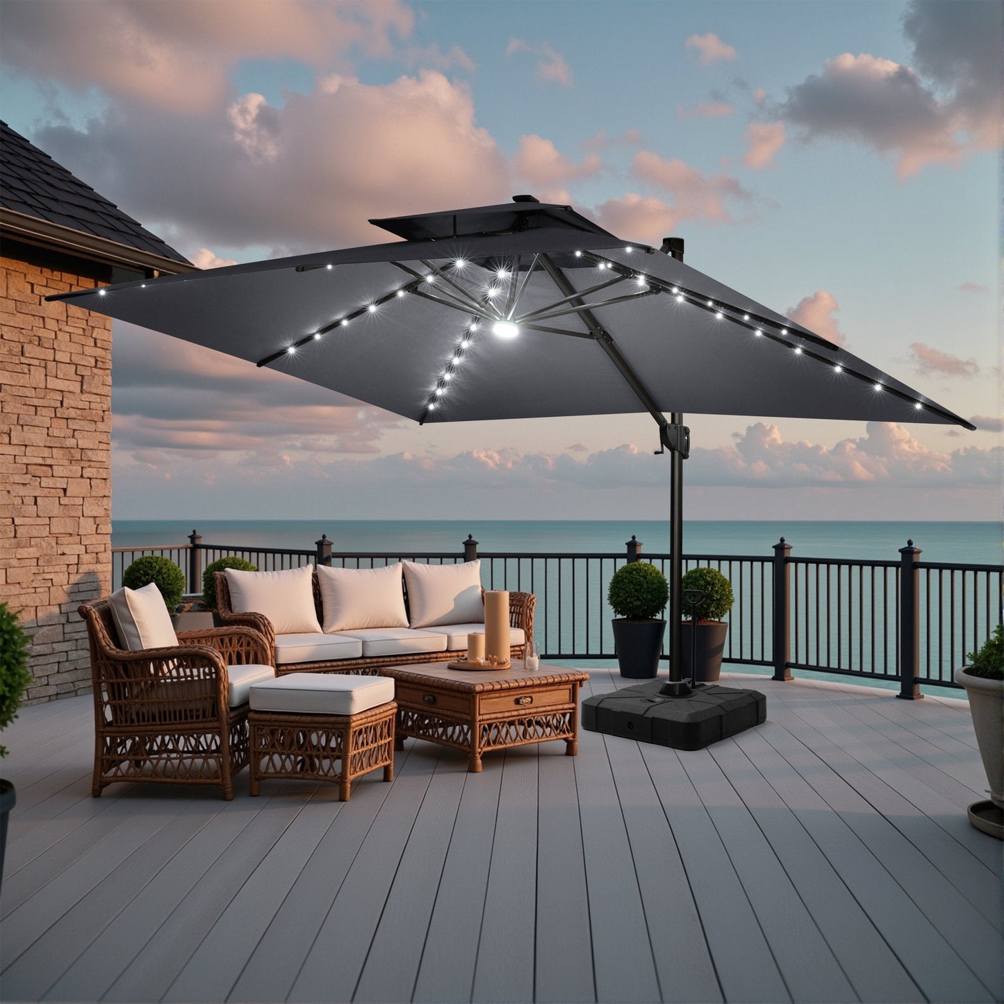 Crestlive dark grey cantilever umbrella with LED lights shading a coastal ocean view deck wicker conversation set