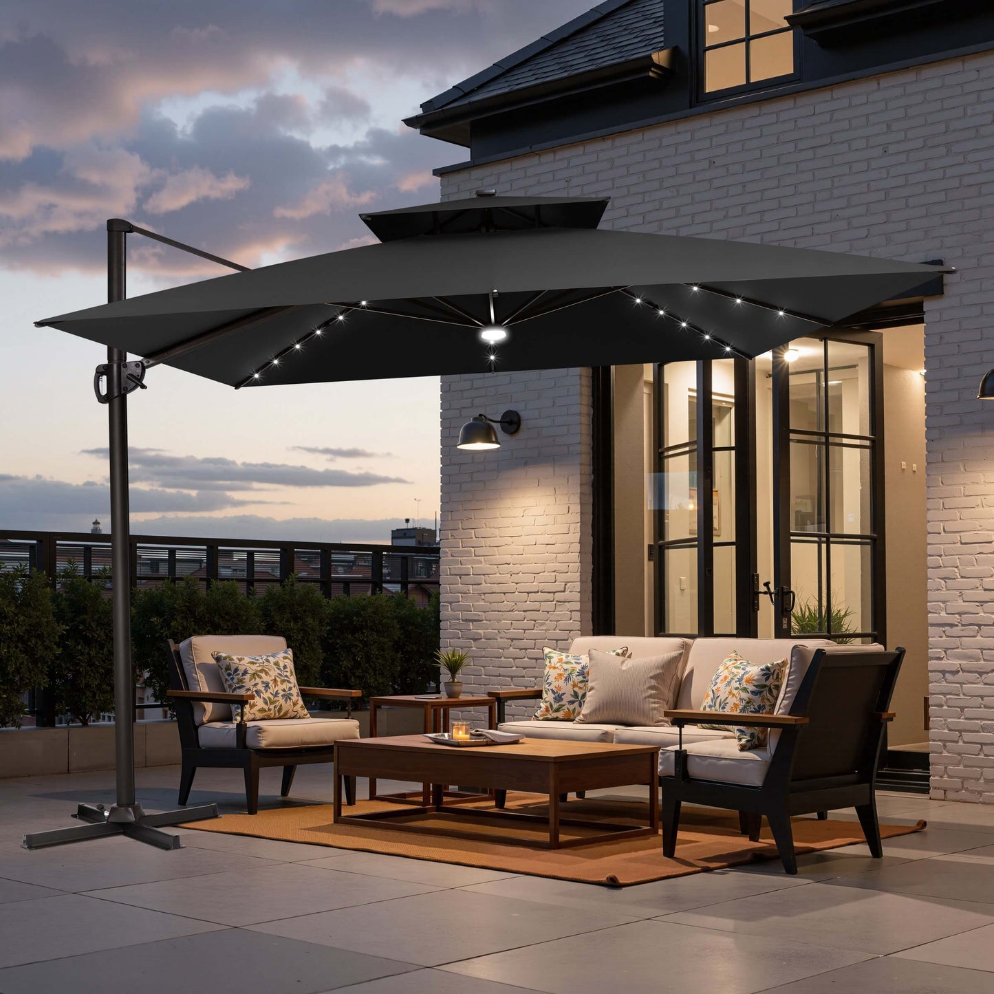 Black double top LED cantilever umbrella with cross base on patio.