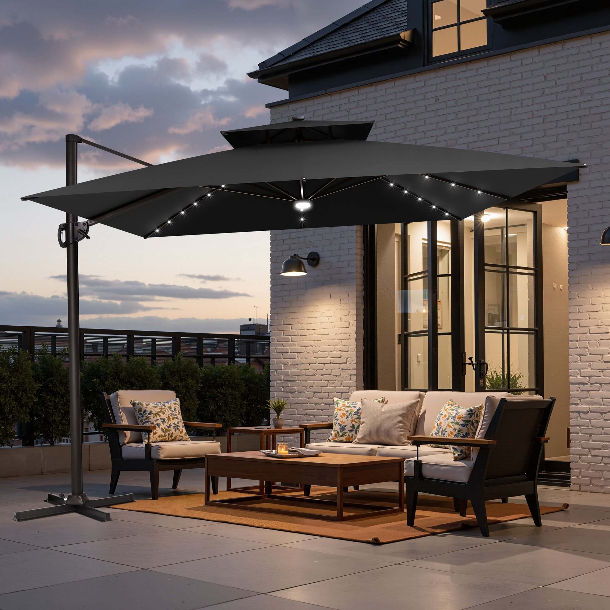 Black double top LED cantilever umbrella with cross base on patio.