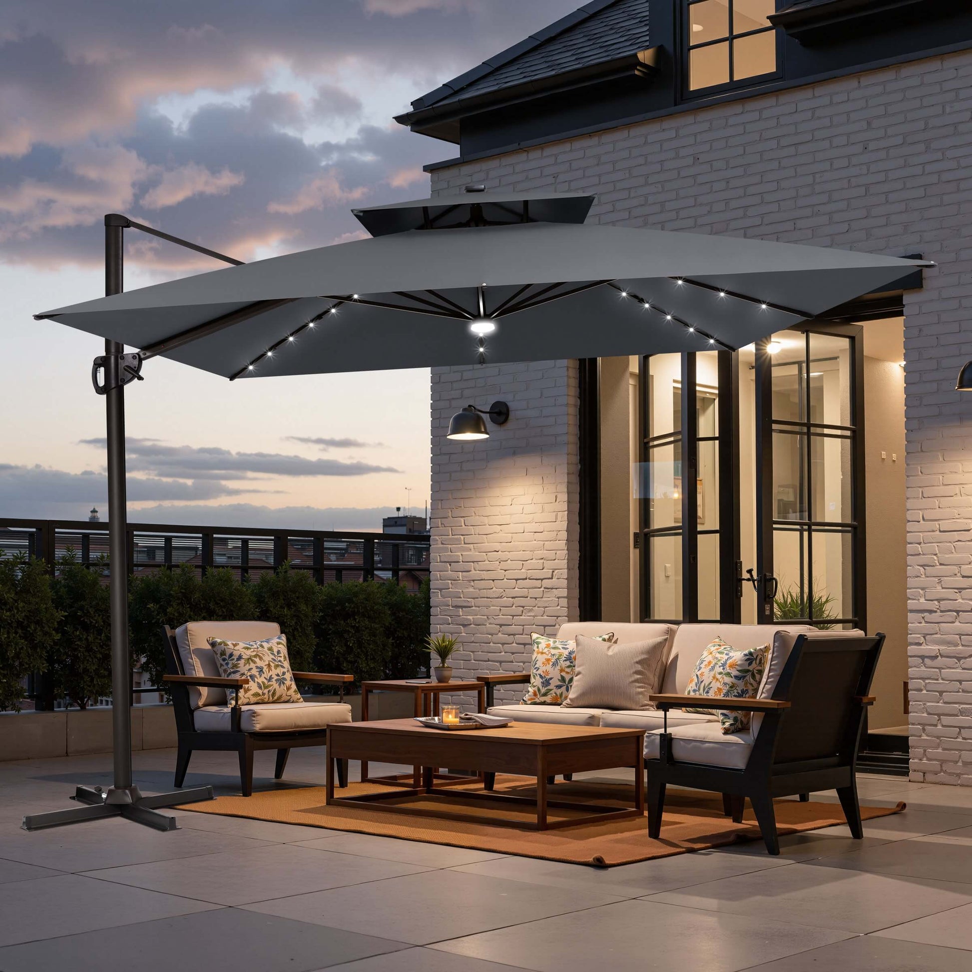 Grey double top LED cantilever umbrella with cross base on patio.