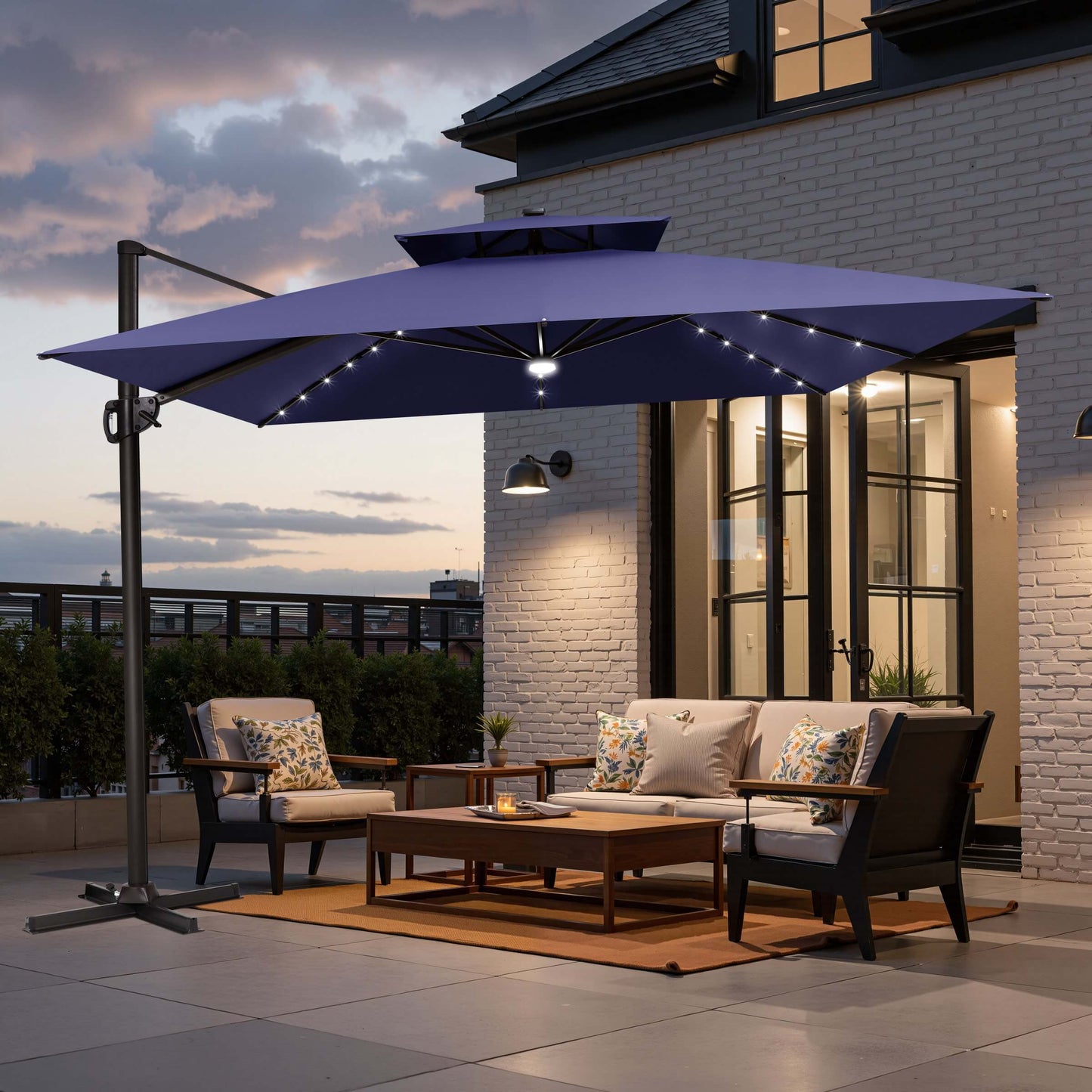 Navy blue double top LED cantilever umbrella with cross base on patio.