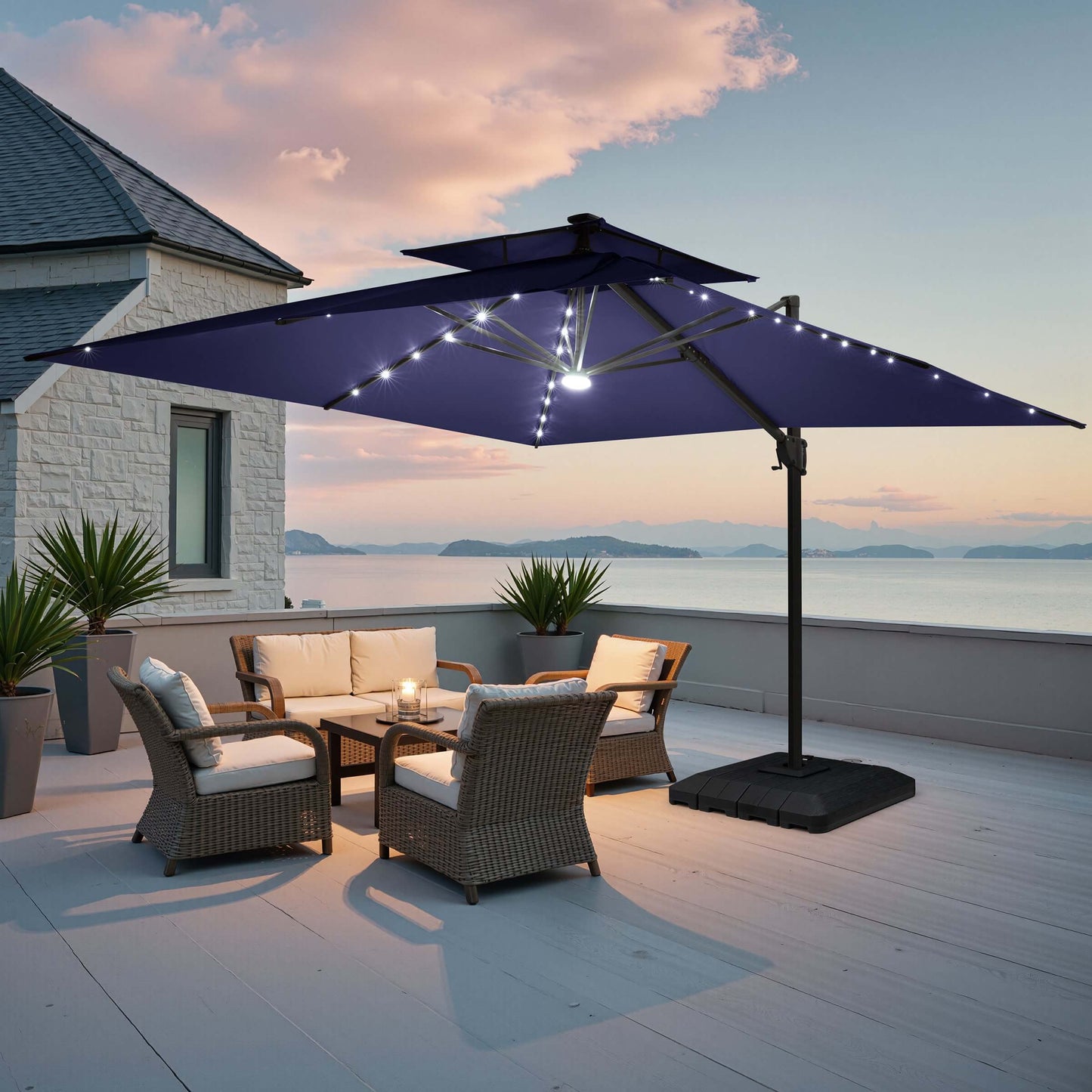 Navy blue double top LED cantilever umbrella with base on deck.