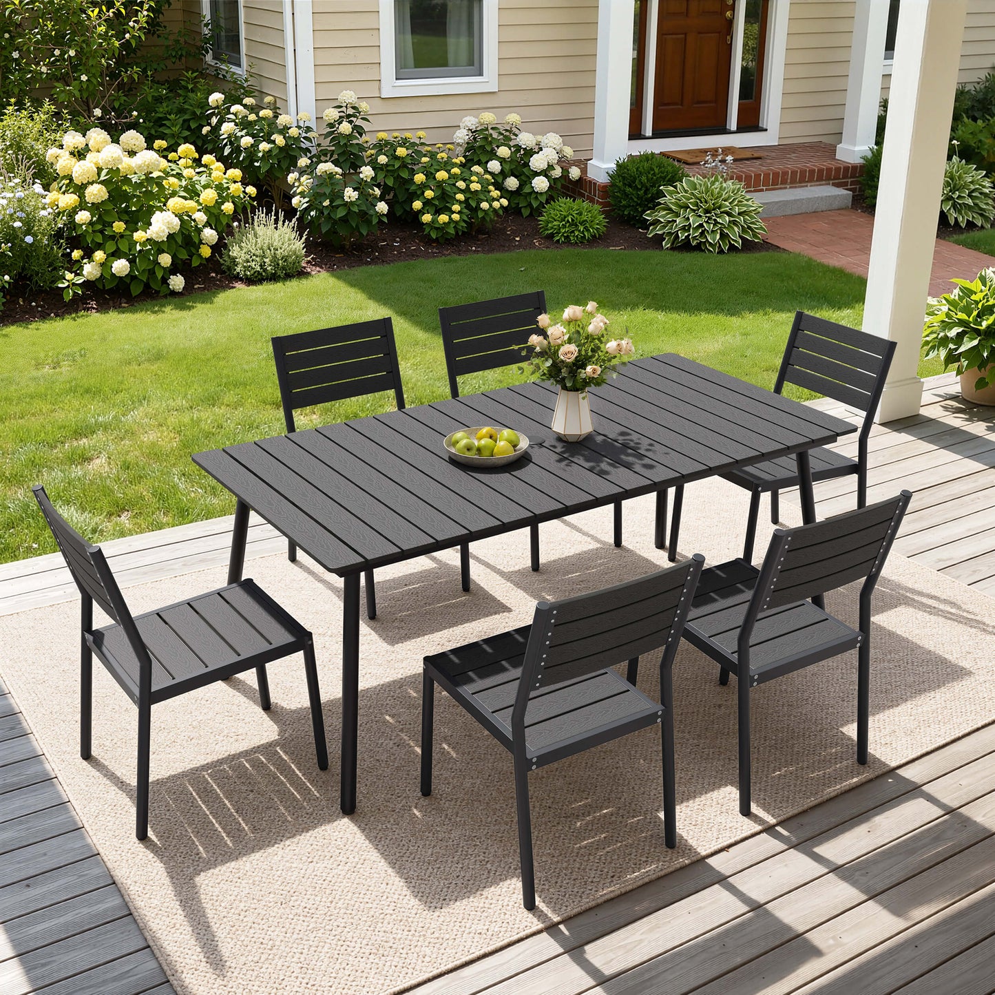 Black 7-piece outdoor dining set with slatted polywood table and 6 armless chairs on a wooden patio deck.