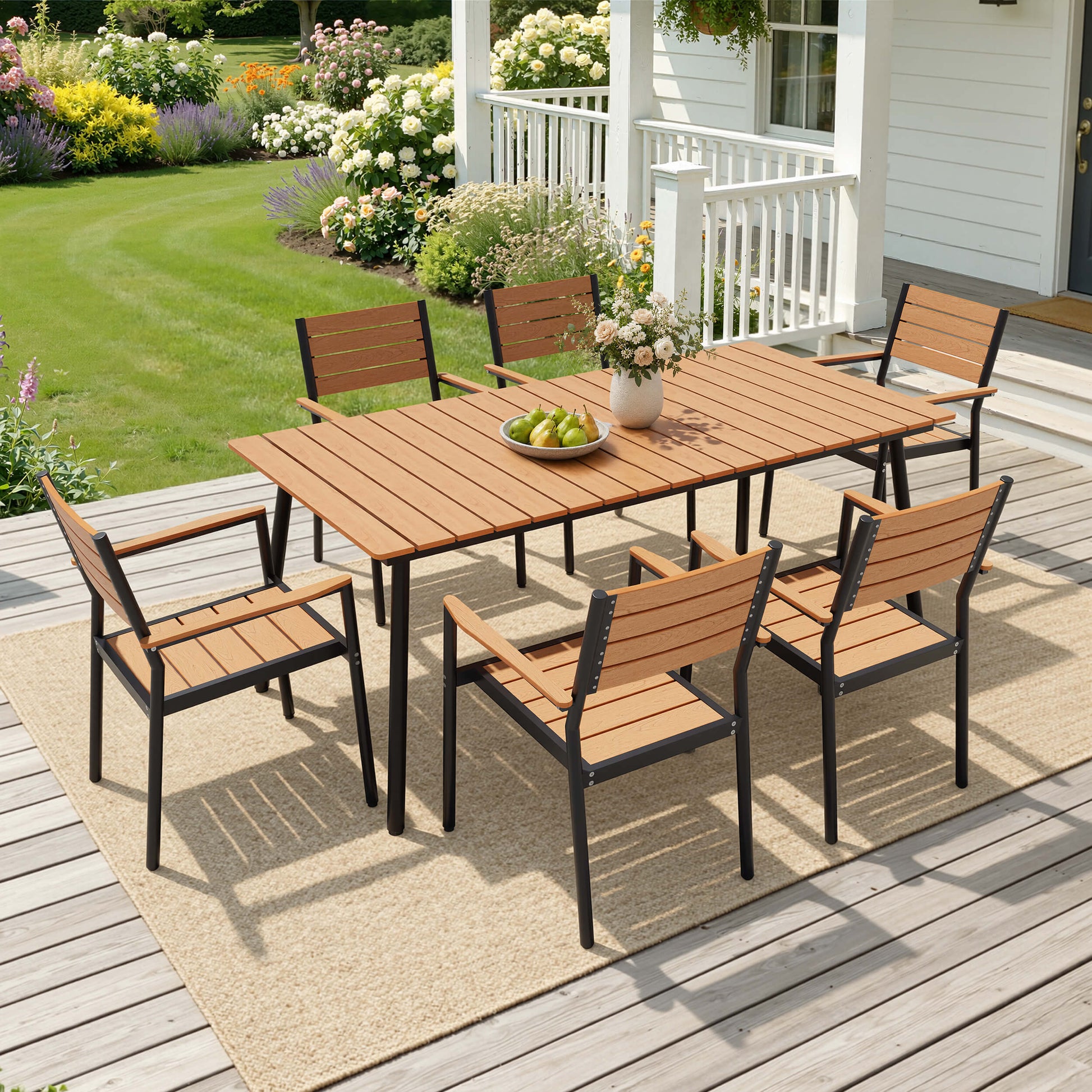 7-piece outdoor patio dining set with teak polywood table set up on a backyard wooden deck.
