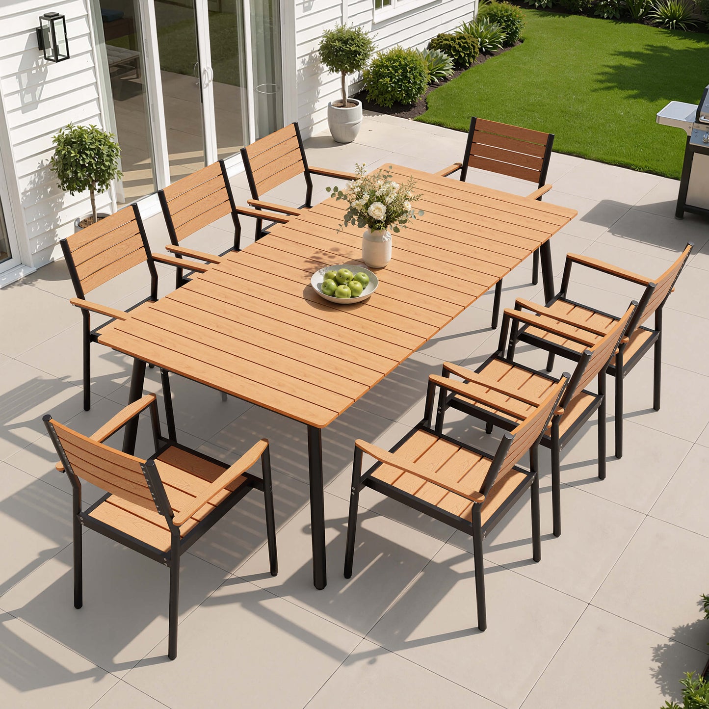 9-piece outdoor patio dining set with polywood table and 8 chairs in backyard setup.