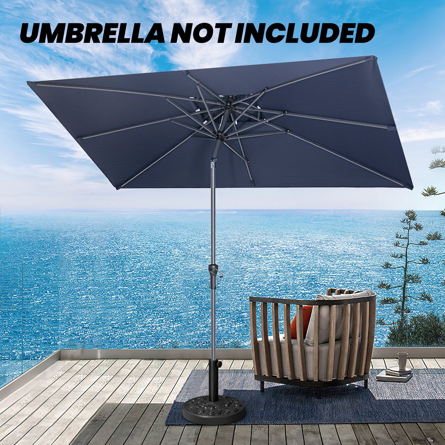 Black 30-46 lbs round floral cement umbrella base supporting an umbrella on a seaside balcony.