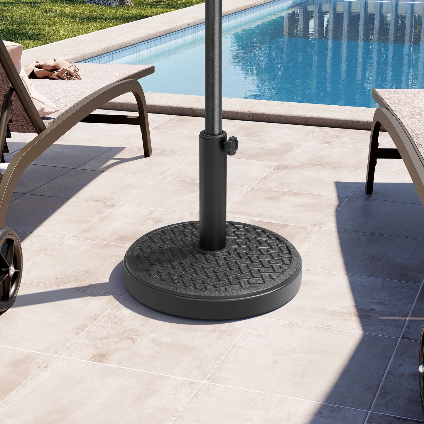 Black 30-45 lbs round concrete market umbrella base between lounge chairs on a sunny poolside patio.