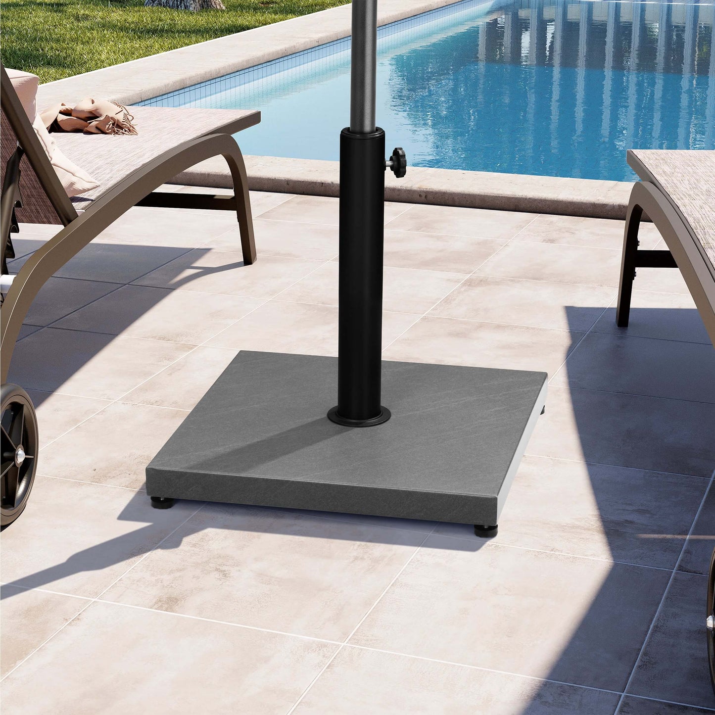 Gray square concrete weighted umbrella base on sunny poolside patio.