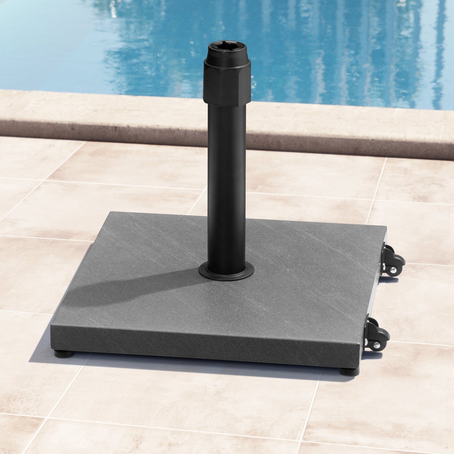 45 lbs square grey steel umbrella base with wheels on a poolside patio.