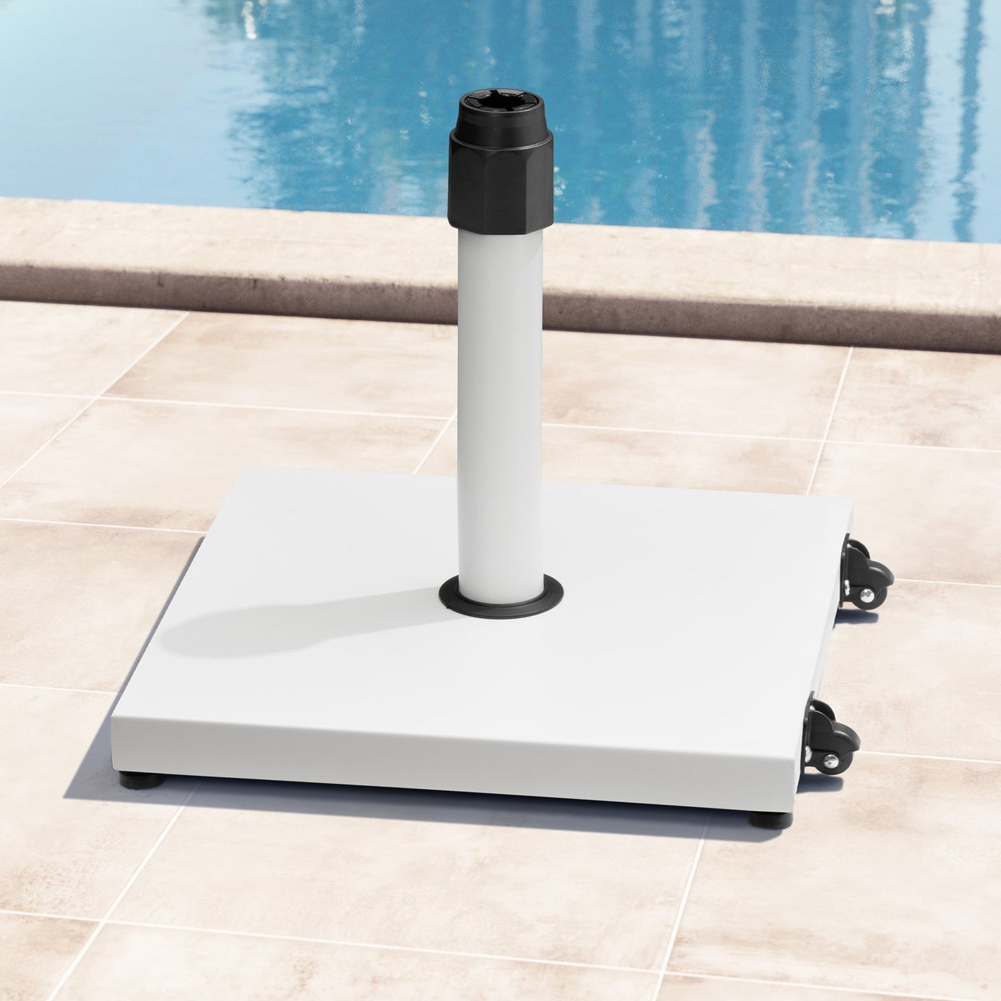 45 lbs square white steel umbrella base with wheels on a poolside patio.
