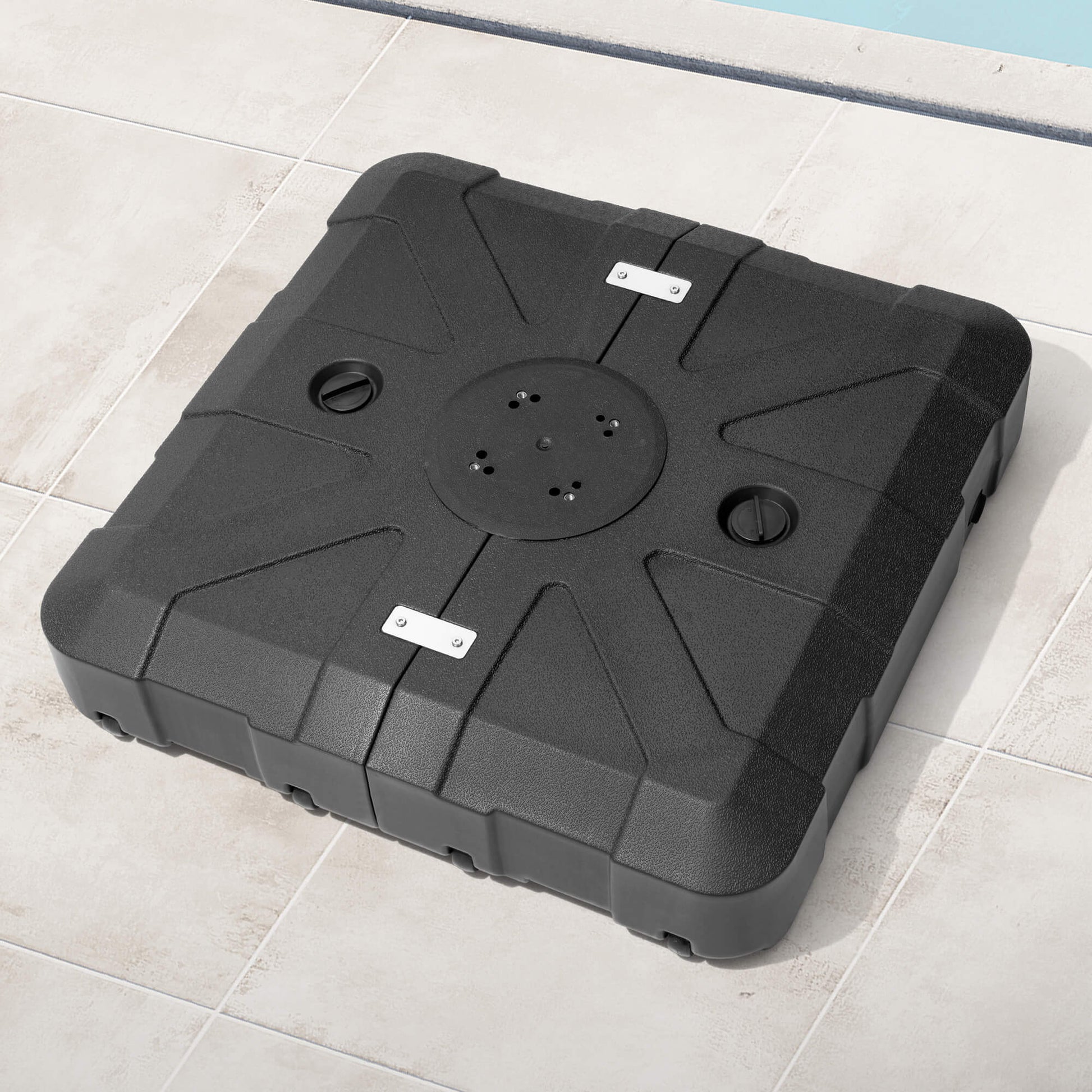 Black square fillable cantilever umbrella base with wheels on poolside patio.
