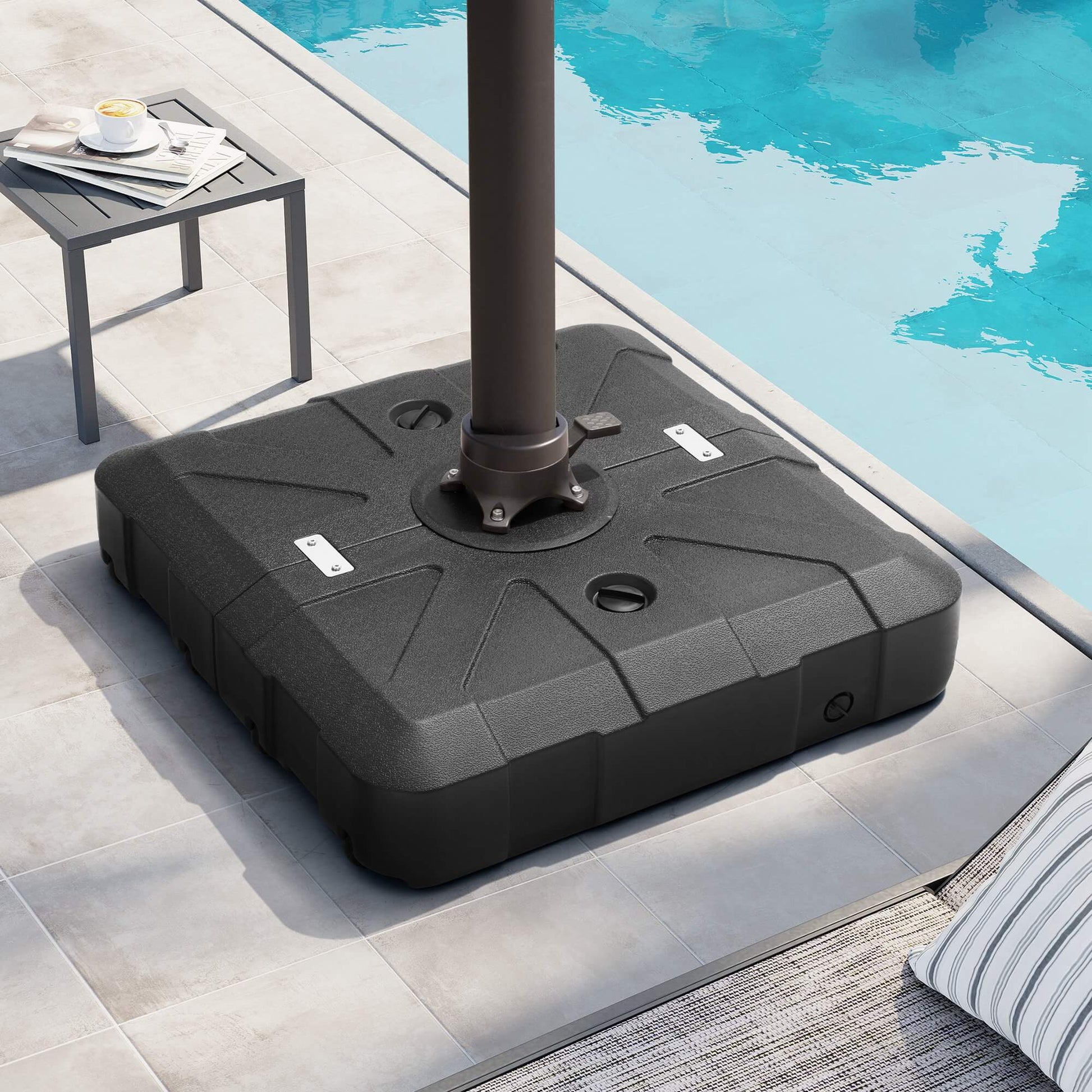 Black square fillable cantilever umbrella base supporting a pole on a sunny poolside patio.
