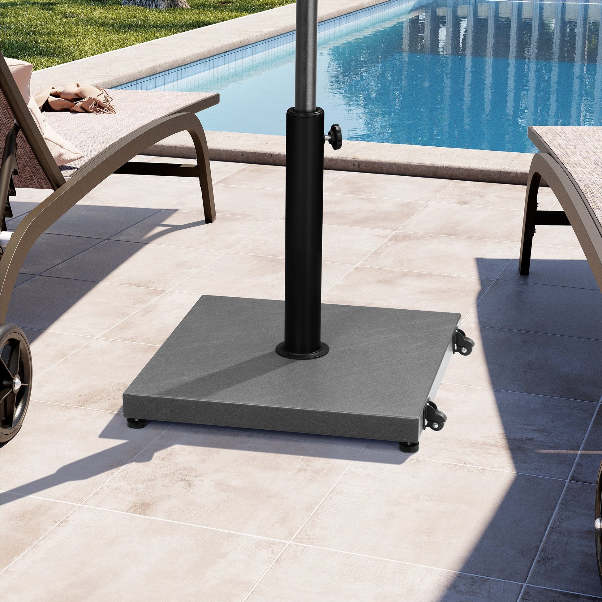 Grey stone square weighted market umbrella base with wheels on poolside patio.