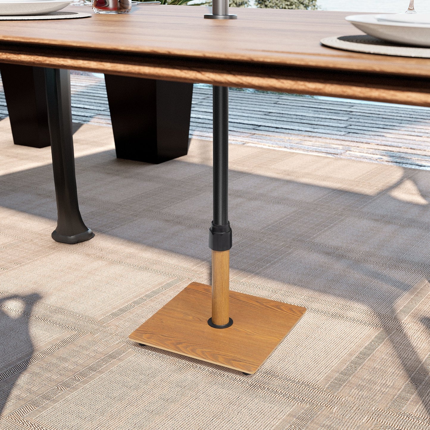 30 lbs square wood grain patio umbrella base securing an umbrella under an outdoor dining table.
