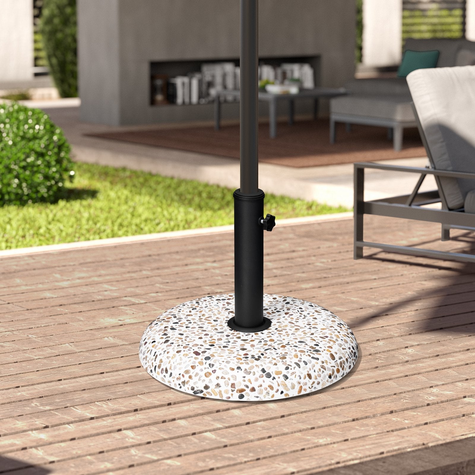 Pebble white 45 lbs heavy duty round cement umbrella base on a wooden patio deck.